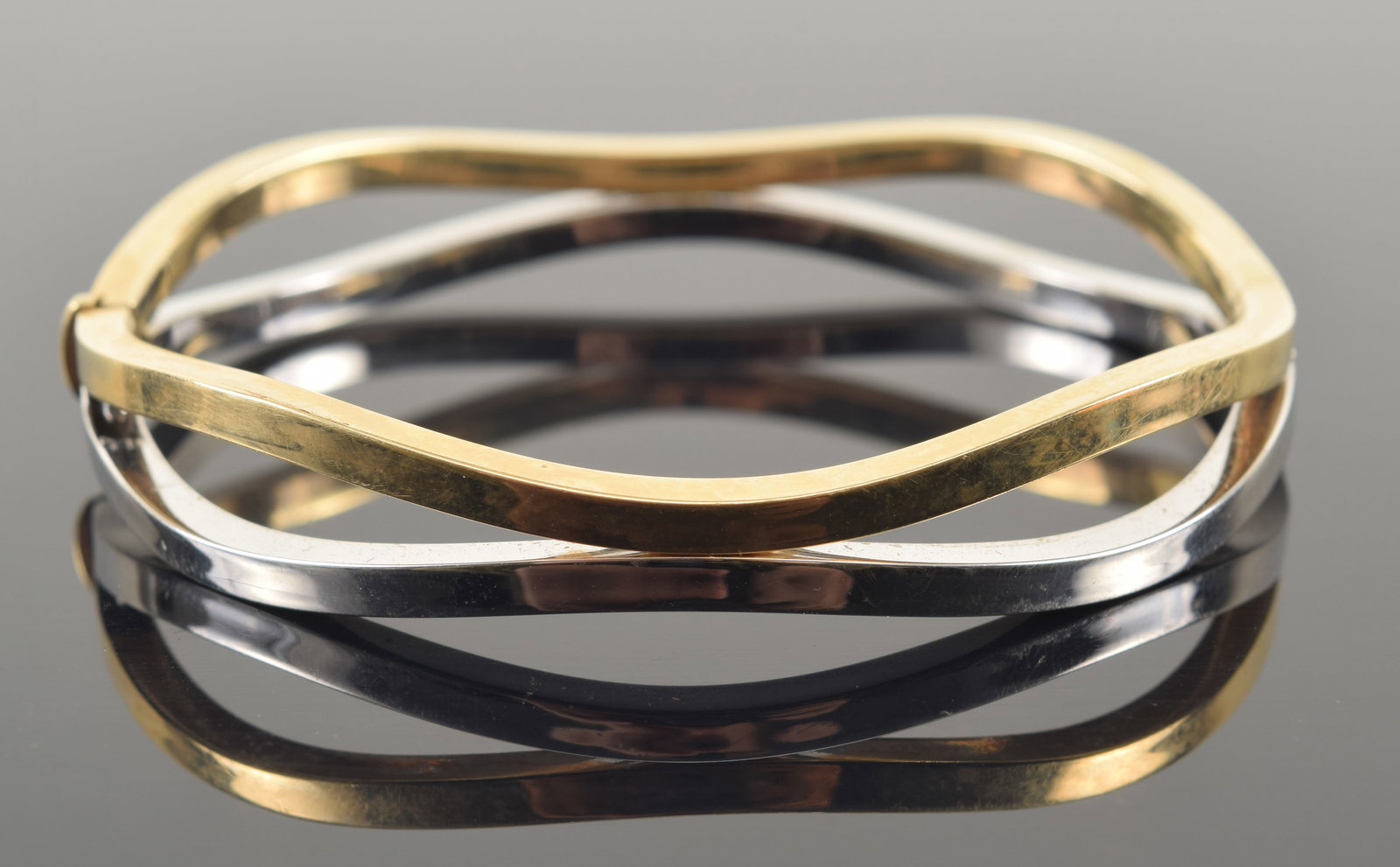 14K white and yellow gold wave form bracelet. Clasp marked 14K. 2.5in wide. 10.3 grams.: 14K white and yellow gold wave form bracelet. Clasp marked 14K. 2.5in wide. 10.3 grams.