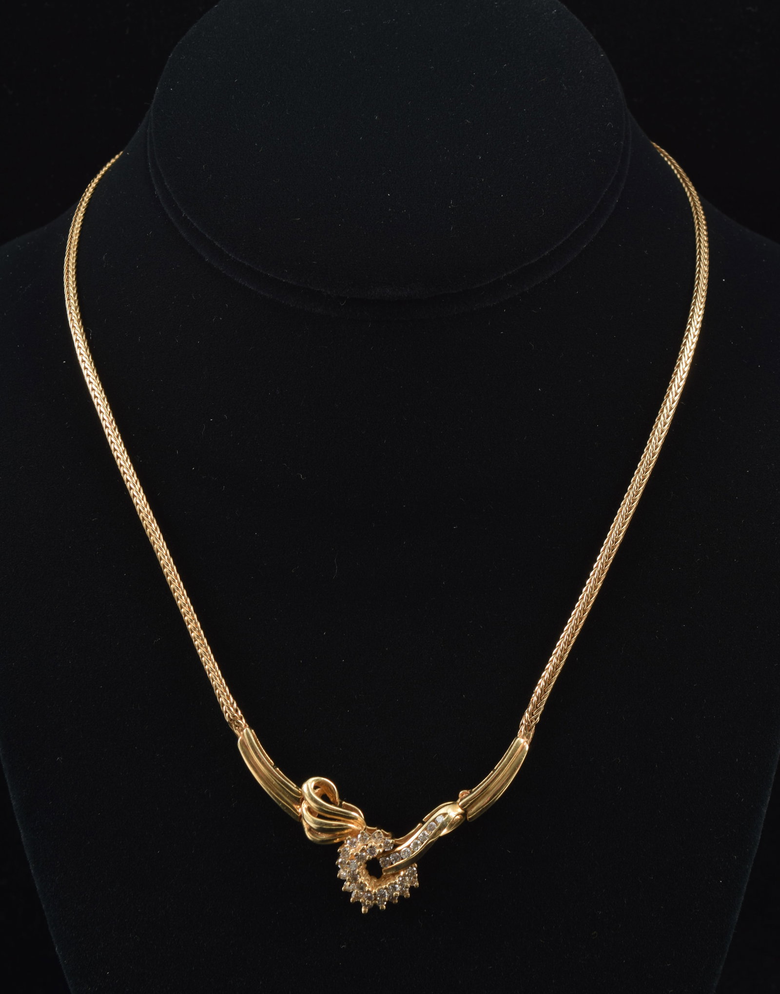 14K gold foxtail link diamond necklace. Partial diamond mounted heart form pendant with scrolled: 14K gold foxtail link diamond necklace. Partial diamond mounted heart form pendant with scrolled setting. Marked 14K on reverse. Approx. 16in length. 15.8 grams.