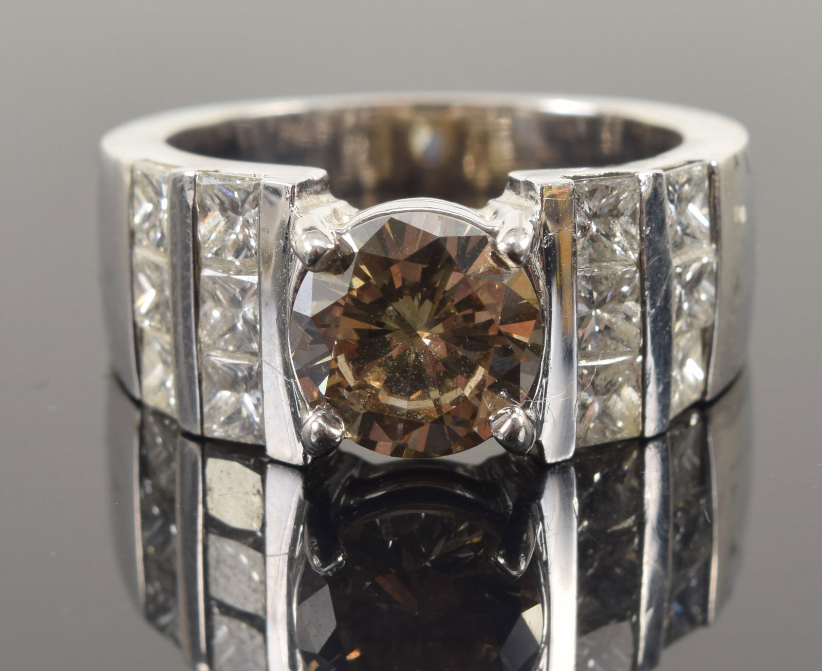Platinum and 14K gold 2.02CT diamond engagement ring. Round brilliant cut center diamond measuring: Platinum and 14K gold 2.02CT diamond engagement ring. Round brilliant cut center diamond measuring 8.29 x 8.31 x 4.64mm and weighing approx. 2.02ct. Color: Slightly greenish brown. Clarity: SI. Flanke