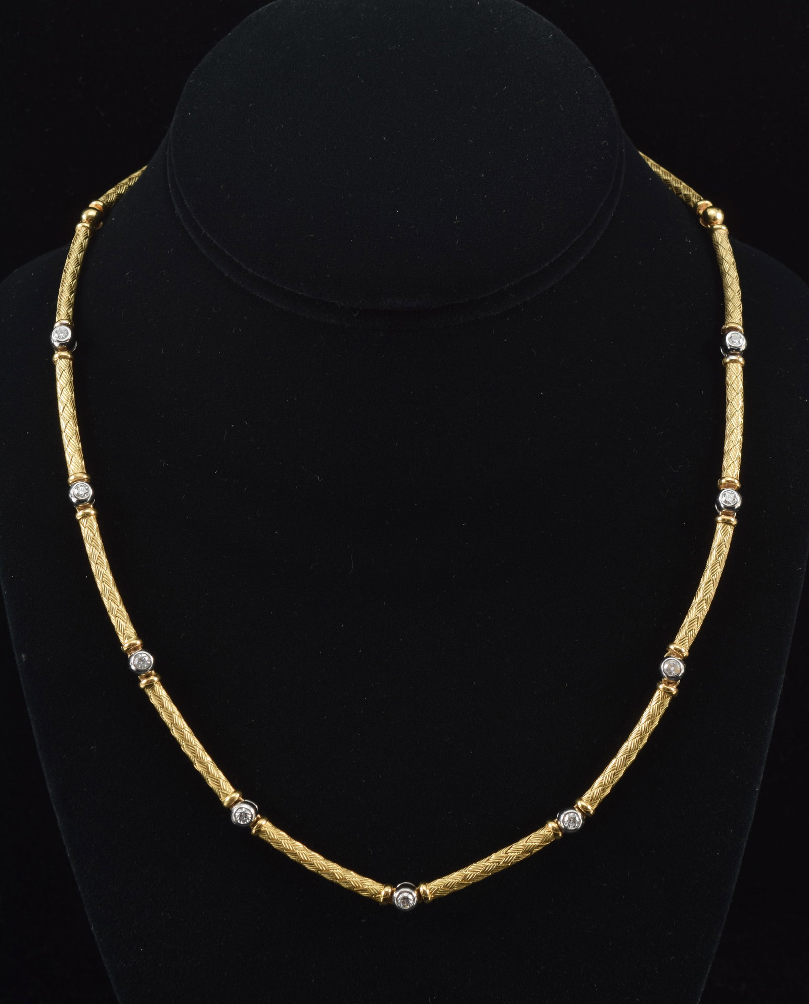 18K gold cylinder link necklace with diamonds. Yellow gold braided cylinder links with spacers of 9: 18K gold cylinder link necklace with diamonds. Yellow gold braided cylinder links with spacers of 9 round cut diamonds set in white gold. Diamonds each about 2.5mm diameter. Marked near clasp 18K Ital