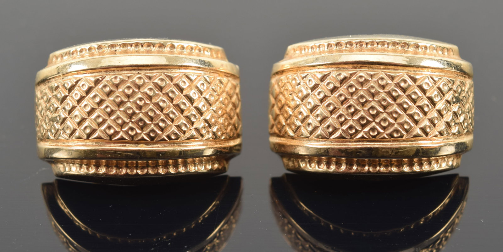 14K gold tiered semi-circle earrings with cross-hatch textured surfaces. Marked 14K. 7/8in length. 7: 14K gold tiered semi-circle earrings with cross-hatch textured surfaces. Marked 14K. 7/8in length. 7 grams.