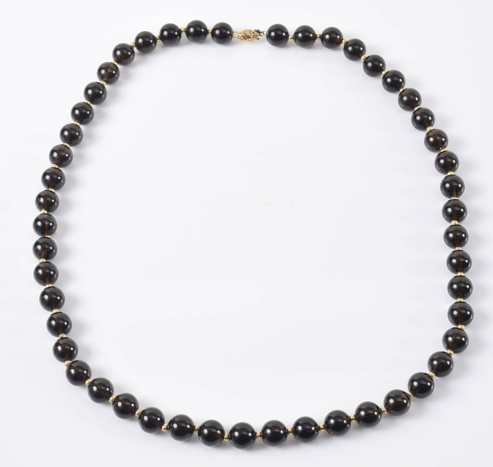 14K gold onyx bead necklace. Gold clasp and spacer beads between polished onyx beads, each measuring: 14K gold onyx bead necklace. Gold clasp and spacer beads between polished onyx beads, each measuring about 10.2mm diameter. 23.5in length.