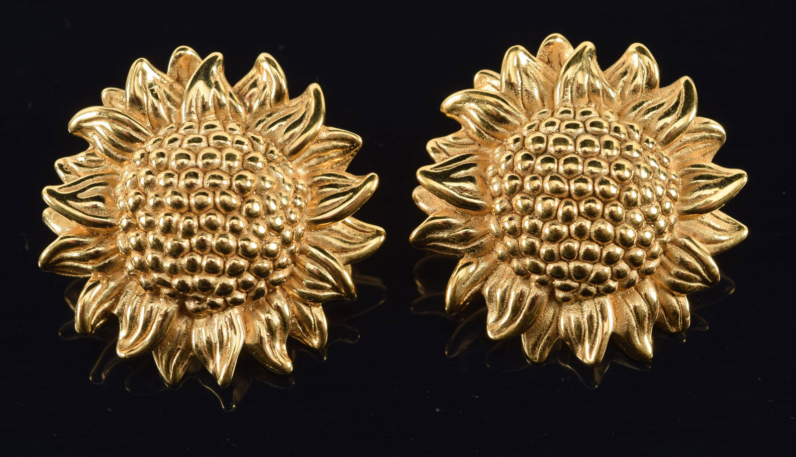 14K gold sunflower form earrings. Hollow cast. Very small slight dent on backside of one near post.: 14K gold sunflower form earrings. Hollow cast. Very small slight dent on backside of one near post. Marked on reverse. 4.9 grams. 1.25in diameter.