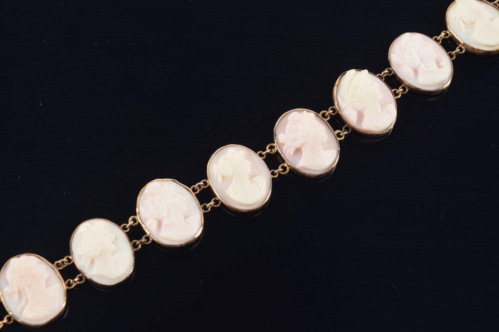 Antique 18K gold shell cameo bracelet. Pink and white shell carvings of beauties. Unmarked but tests: Antique 18K gold shell cameo bracelet. Pink and white shell carvings of beauties. Unmarked but tests as 18K. 7.25in length. 15 grams.