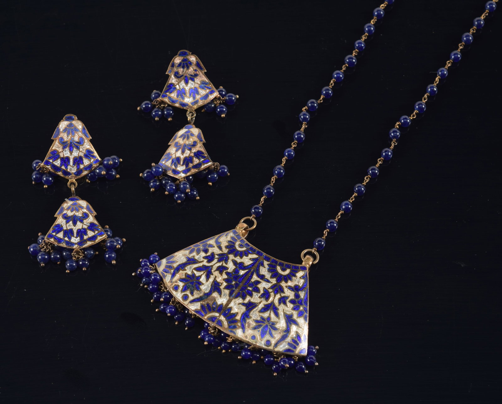 Antique gilt silver enamel decorated necklace and earring set. Floral arabesque design with blue: Antique gilt silver enamel decorated necklace and earring set. Floral arabesque design with blue glass beads. Unmarked. Earrings with damages/loss to clips. Necklace length: 20in. Pendant width: 2in. 
