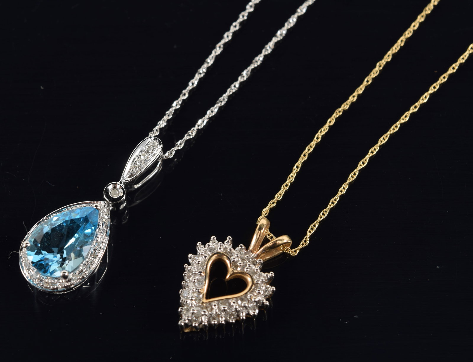 2 gold necklaces. 1) 14K white gold topaz and diamond mounted pendant necklace. Clasp marked 14K. (1 of 4)