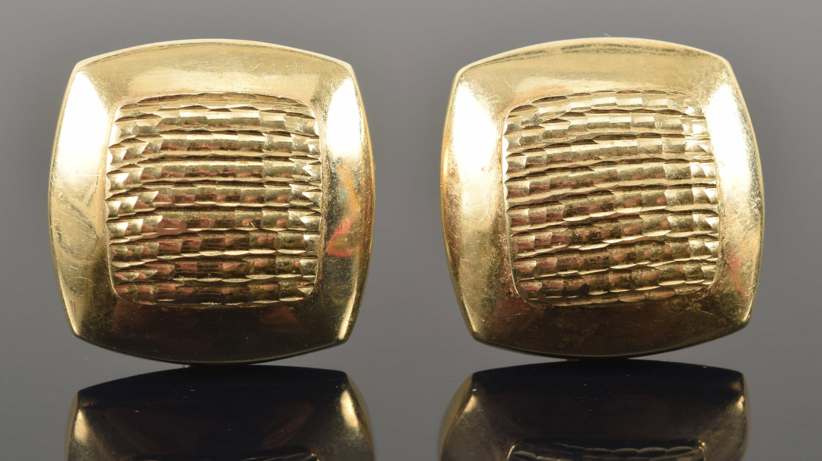 14K gold cushion form earrings with raised textured central surface. Stamped 14K and Italy. 7/8in (1 of 5)