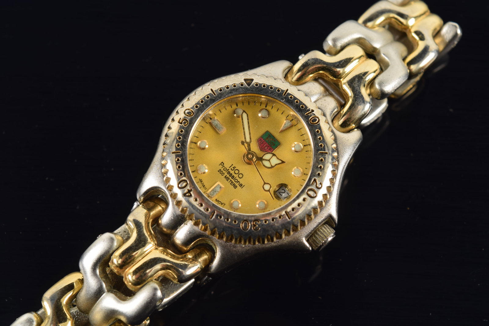 Tag Heuer 1500 Professional ladies' wristwatch. Alternating gold and steel stone links. Case: Tag Heuer 1500 Professional ladies' wristwatch. Alternating gold and steel stone links. Case diameter: 29mm (inlcuding winder). Light corrosion and wear to interior of band.