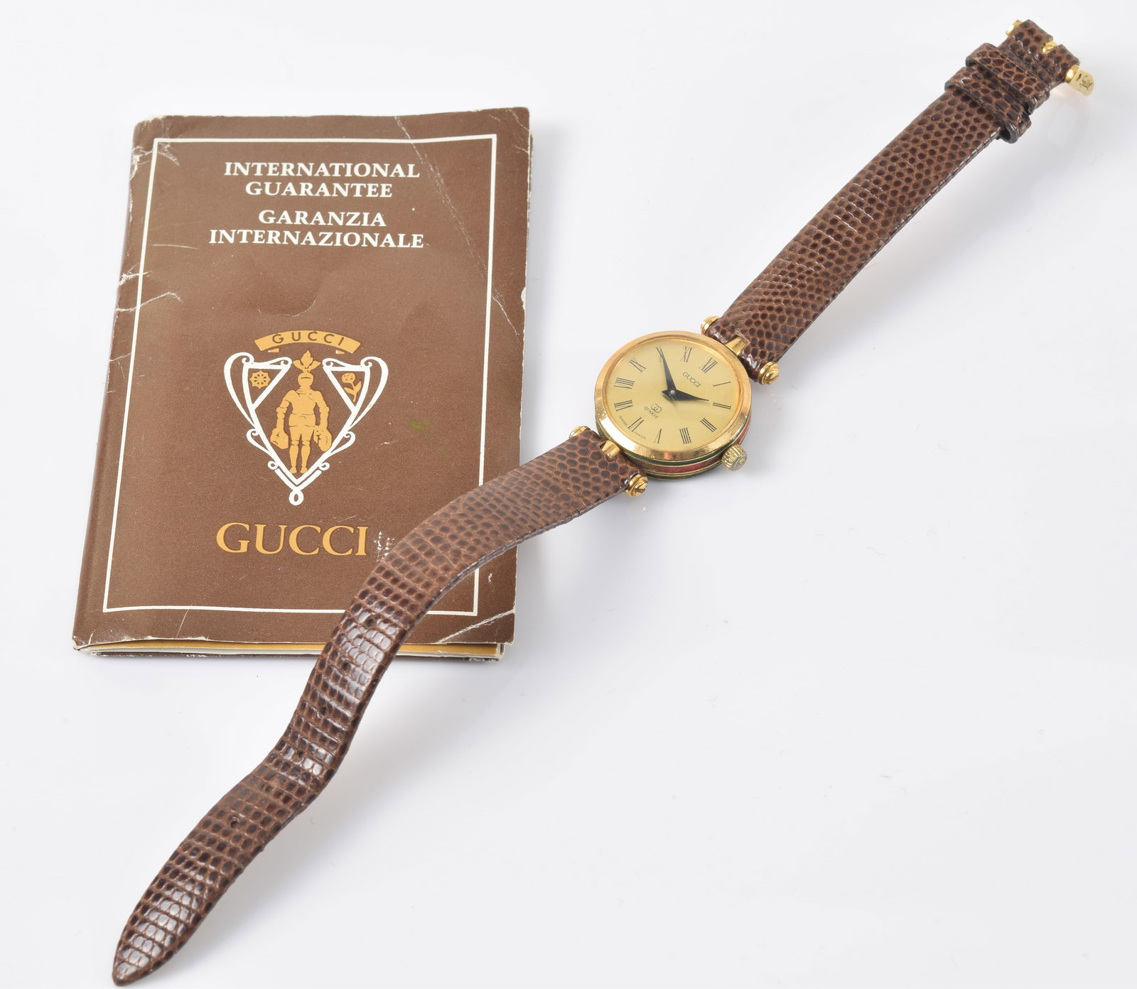 Vintage Gucci ladies' enameled wristwatch with papers. Some scratching to crystal and wear to: Vintage Gucci ladies' enameled wristwatch with papers. Some scratching to crystal and wear to enamel. Band: 8in length.