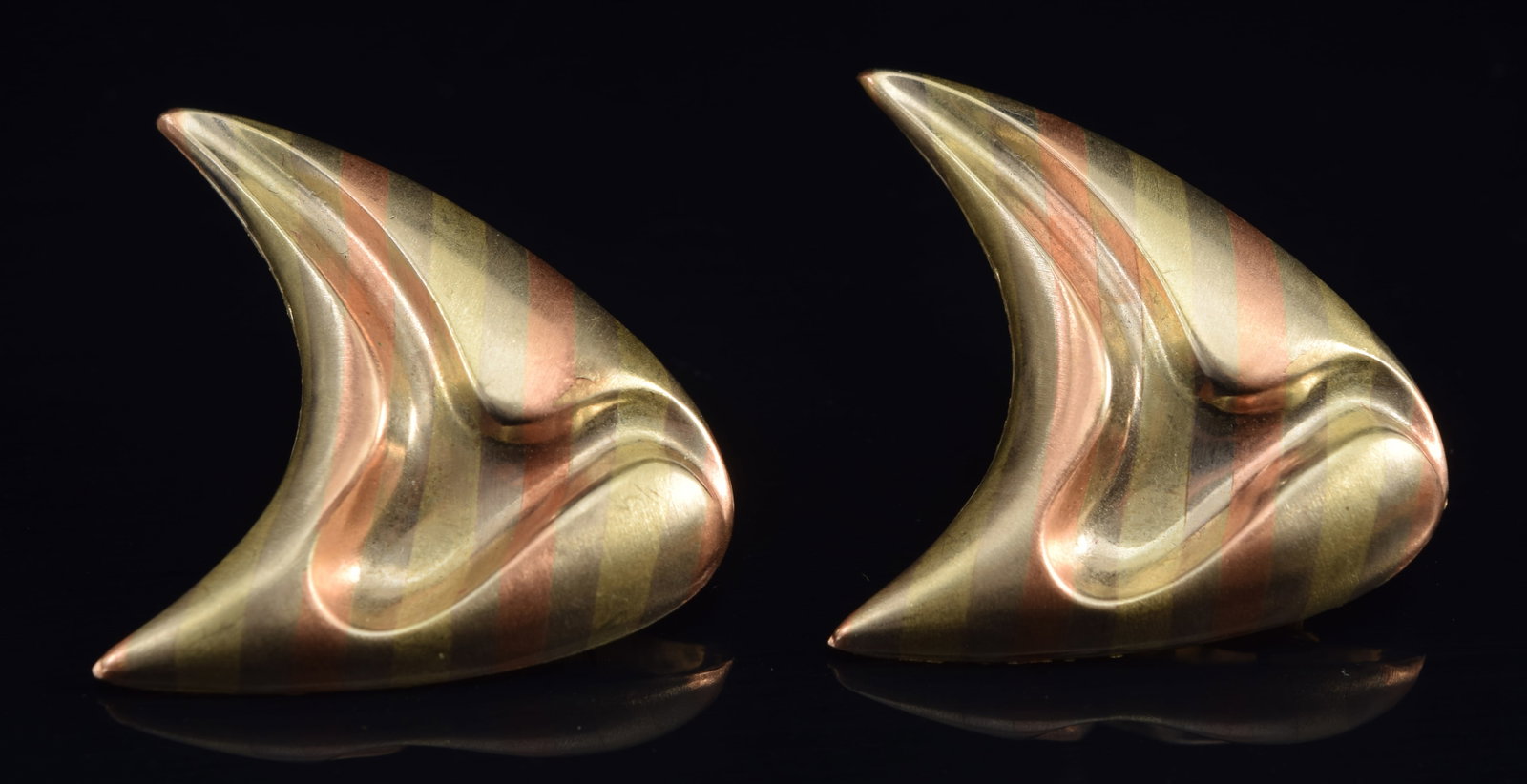 14K tri-color gold modern triangle form earrings with recessed contour depression. Bands of white,: 14K tri-color gold modern triangle form earrings with recessed contour depression. Bands of white, yellow and rose gold. 3.5 grams.
