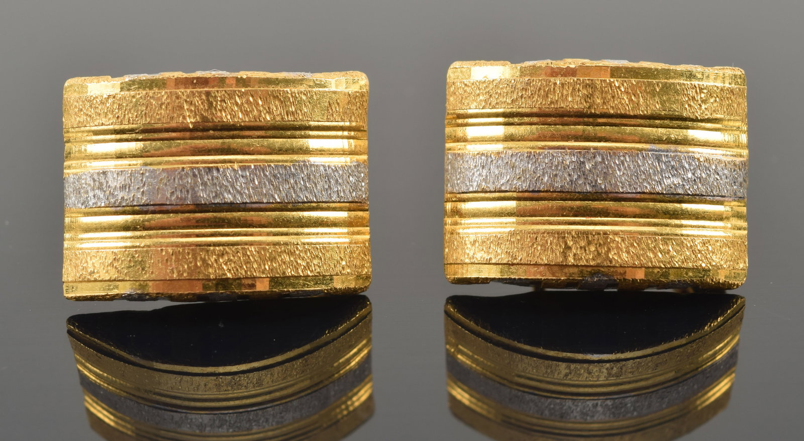 22K dual color gold earrings with sandblast textured design. Stamped 916 for 22K on the clasps.: 22K dual color gold earrings with sandblast textured design. Stamped 916 for 22K on the clasps. 0.75in length. 7.8 grams.