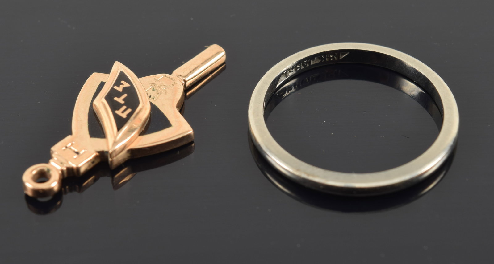 18K white gold band and vintage 10K gold enamel decorated fraternal watch key. Band ring size 6.5.: 18K white gold band and vintage 10K gold enamel decorated fraternal watch key. Band ring size 6.5. 2.1 grams and 2.7 grams respectively.