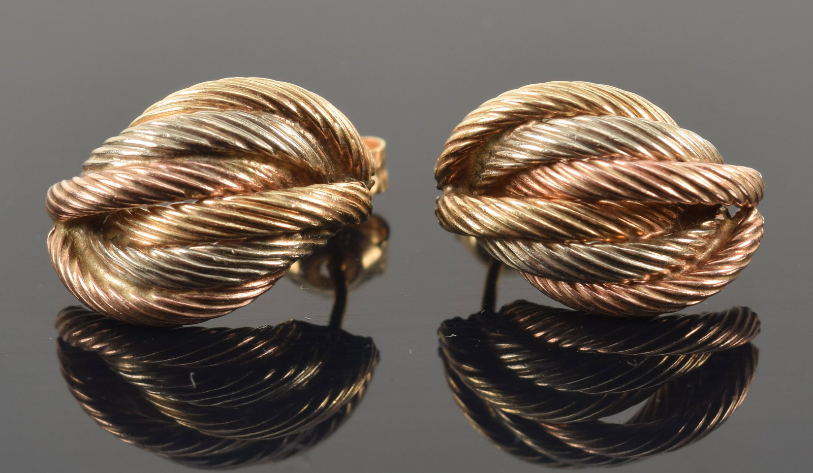 14K tri-color gold braided half hoop earrings. Posts hallmarked. 0.5in length. 2.3 grams.: 14K tri-color gold braided half hoop earrings. Posts hallmarked. 0.5in length. 2.3 grams.