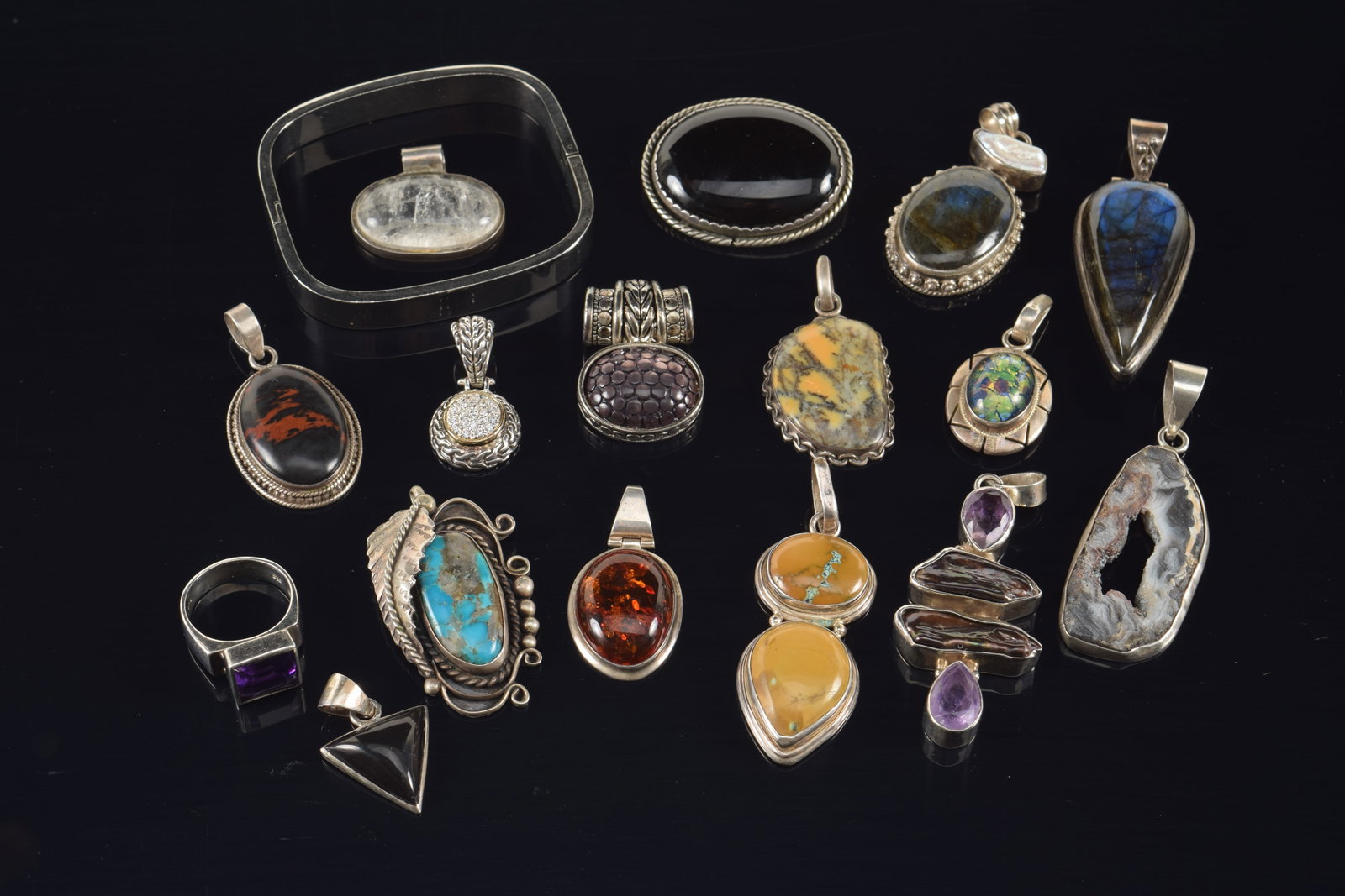 Assortment of stone mounted silver designer jewelry, including southwest turquoise feather pin,: Assortment of stone mounted silver designer jewelry, including southwest turquoise feather pin, amber pendant, amethyst ring, etc.