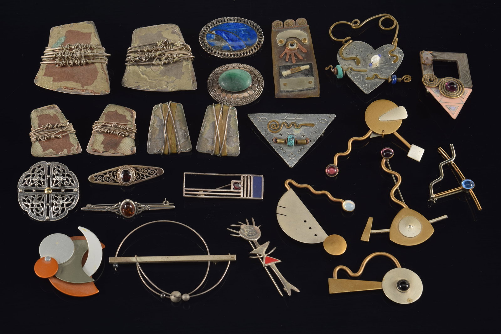 Large lot of modern mixed metal designer jewelry, including silver. To include: geometric abstract: Large lot of modern mixed metal designer jewelry, including silver. To include: geometric abstract designs, brutalist pieces, heart and triangle silver pins with pictographs marked O. Miller, several 