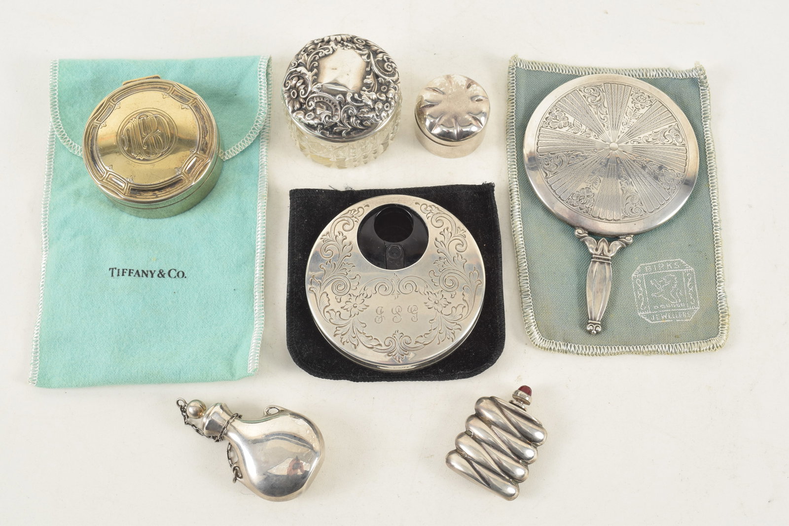 Collection of sterling items, including 4 snuff related items, a Tiffany and Co gold wash curio box,: Collection of sterling items, including 4 snuff related items, a Tiffany and Co gold wash curio box, a gold wash perfume funnel, a Birks small hand mirror, a covered cosmetic jar and a Kirk Steiff mod