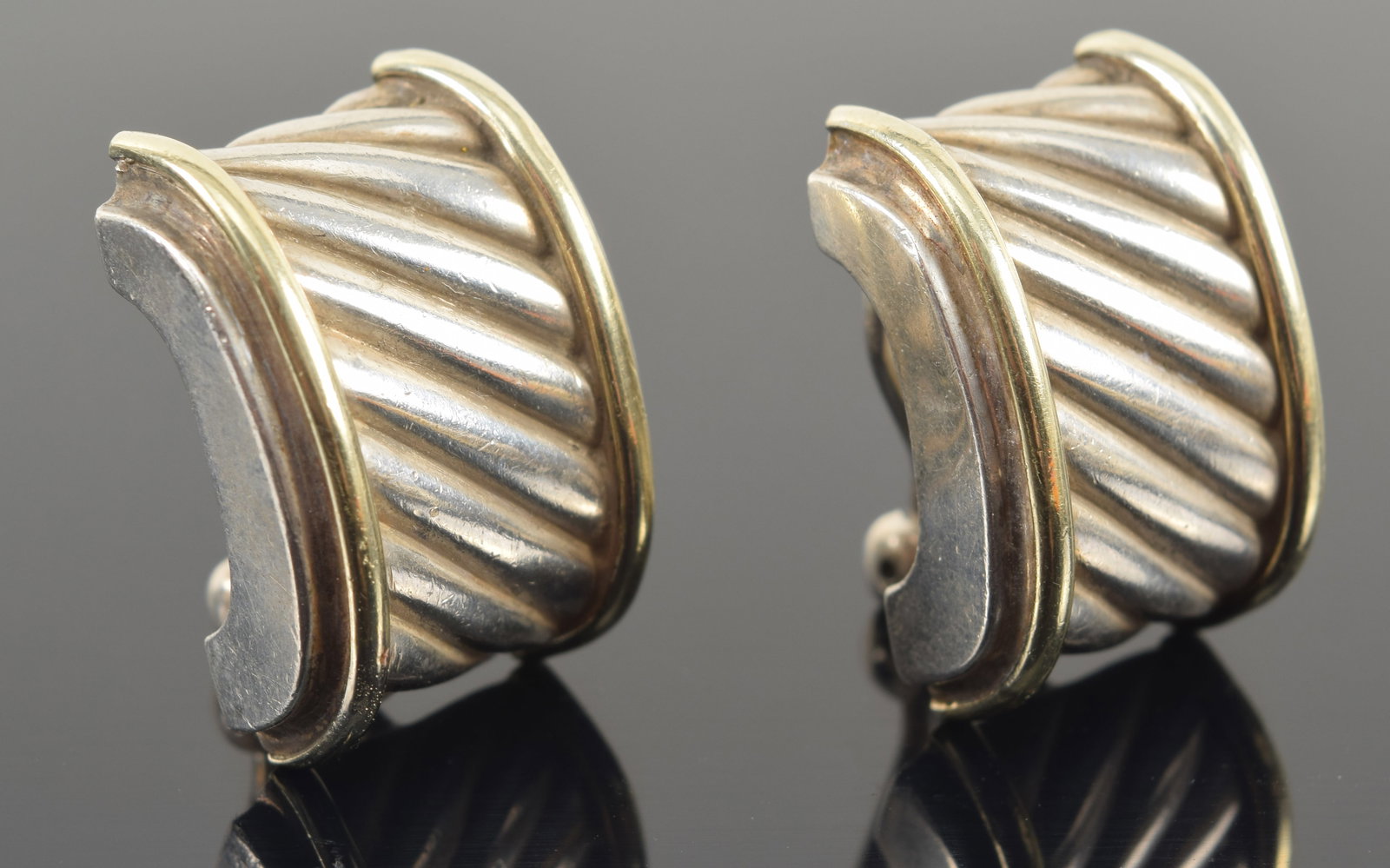 David Yurman 14K gold and sterling silver earrings with omega backs. Signed and marked on reverse.: David Yurman 14K gold and sterling silver earrings with omega backs. Signed and marked on reverse. 14.7 grams. 0.75in length.