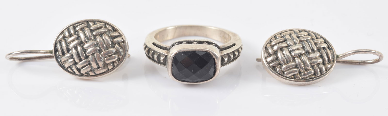 David Yurman sterling silver jewelry. 1) Pink ring with black faceted stone. Signed. Ring size 5. 2): David Yurman sterling silver jewelry. 1) Pink ring with black faceted stone. Signed. Ring size 5. 2) Pair of dangle earrings with basket weave design. Signed on reverse. 9 grams total weight.