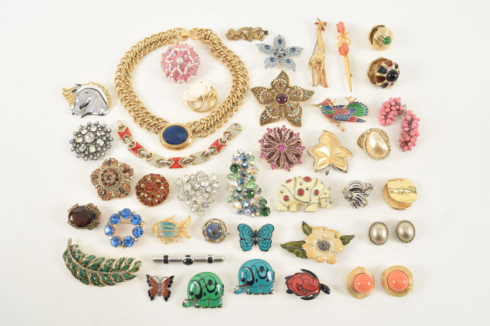 Large lot of fashion jewelry pins, earrings and necklaces. Including: Lanvin Paris enameled: Large lot of fashion jewelry pins, earrings and necklaces. Including: Lanvin Paris enameled rhinoceros pin, Eisenberg enameled figural pins, Ciner earrings, rhinestone pins, and more.