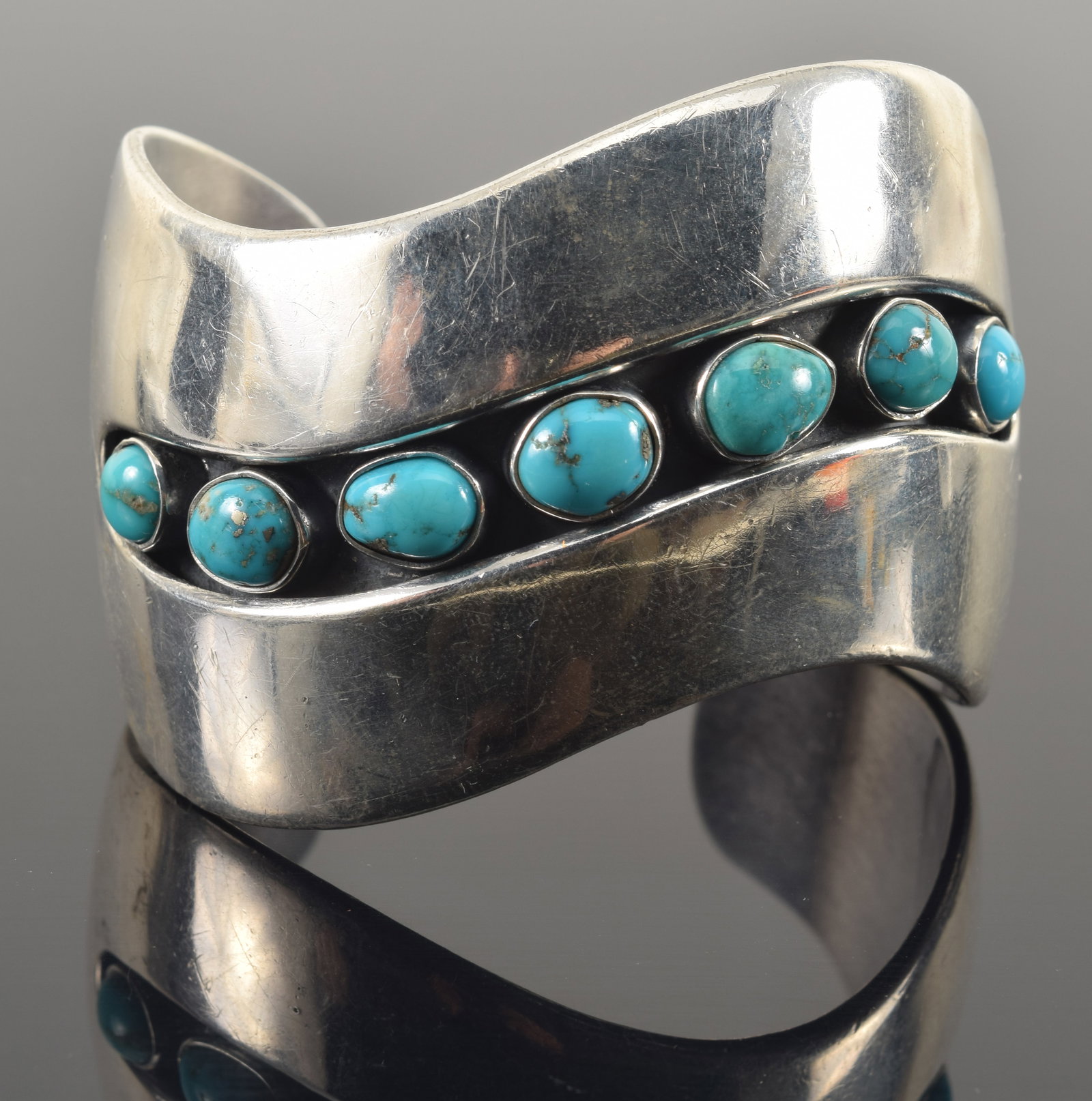 George Kee Navajo sterling silver cuff bracelet with contoured channel set with turquoise stones.: George Kee Navajo sterling silver cuff bracelet with contoured channel set with turquoise stones. Marked on interior. 3.3 ozt.