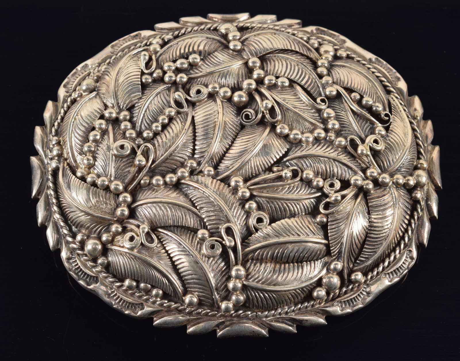 Ornate southwest Native American sterling silver belt buckle. Intricate foliate design with bead: Ornate southwest Native American sterling silver belt buckle. Intricate foliate design with bead borders and scrolling decoration. Marked sterling. 3.25in wide. 2.3 ozt.