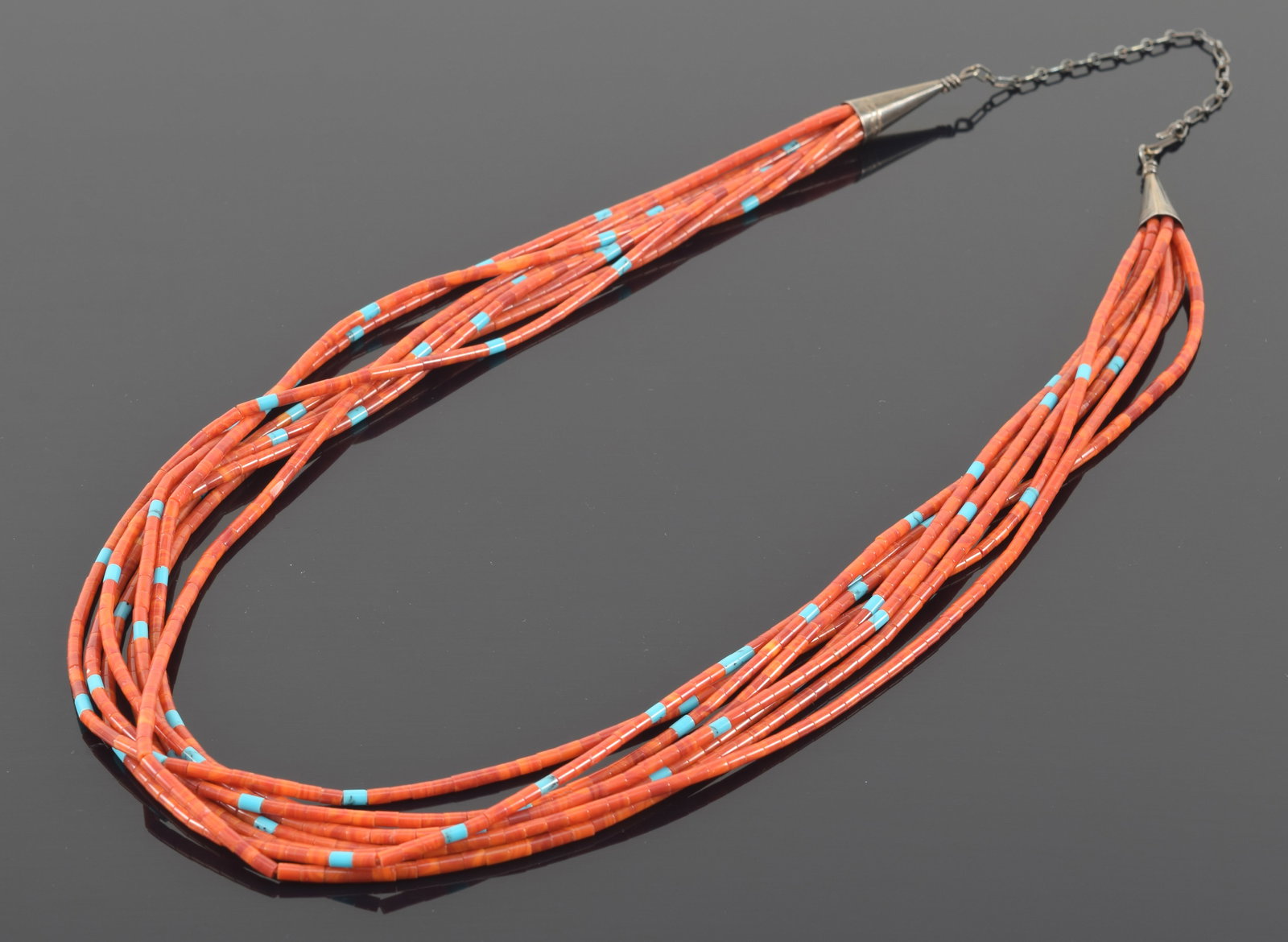 Southwestern Native American silver mounted coral and turquoise beaded necklace. 8 strands with: Southwestern Native American silver mounted coral and turquoise beaded necklace. 8 strands with cylindrical beads. 23.5in length.
