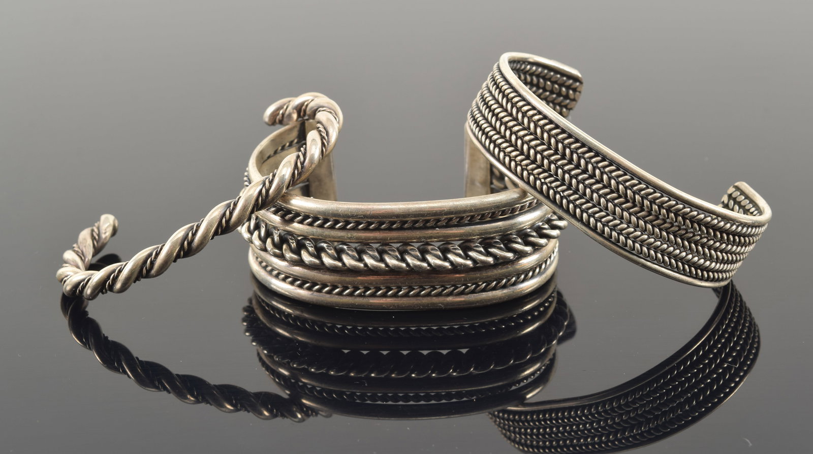 3 southwest style silver cuff bracelets with braided designs. Unmarked. Largest: 3 1/8in wide. 4.8 (1 of 7)