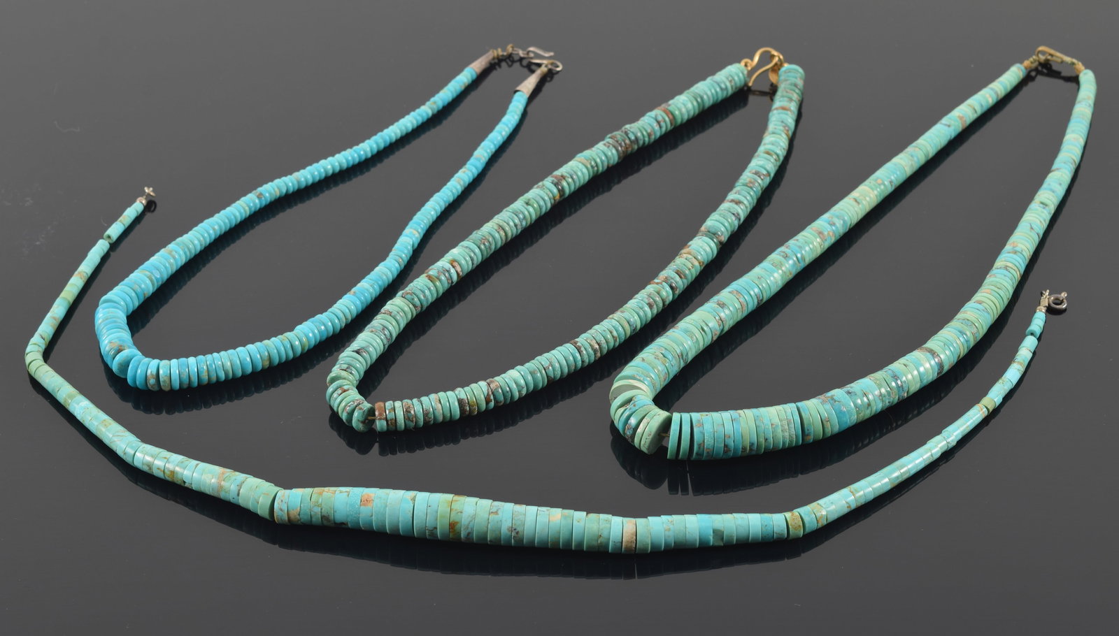 4 southwest style turquoise necklaces. 3 with graduated discs, one non-graduated discs. Each about (1 of 5)