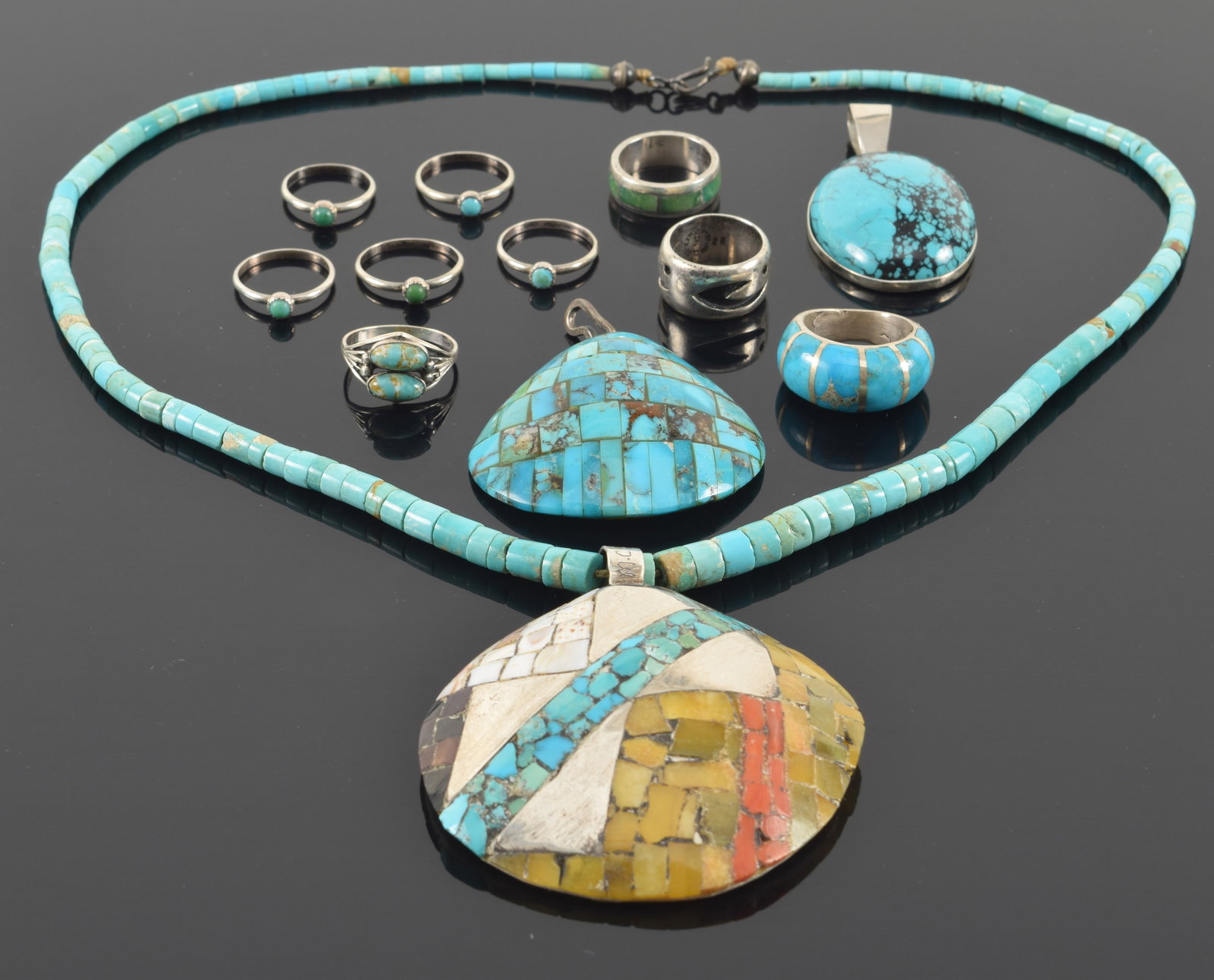 Lot of southwest Native American silver jewelry. To include: 1) 8 turquoise mounted rings and one: Lot of southwest Native American silver jewelry. To include: 1) 8 turquoise mounted rings and one carved silver ring. 2) Oval turquoise pendant. 3) Turquoise mounted shell pendant. 4) Santa Domingo Pu