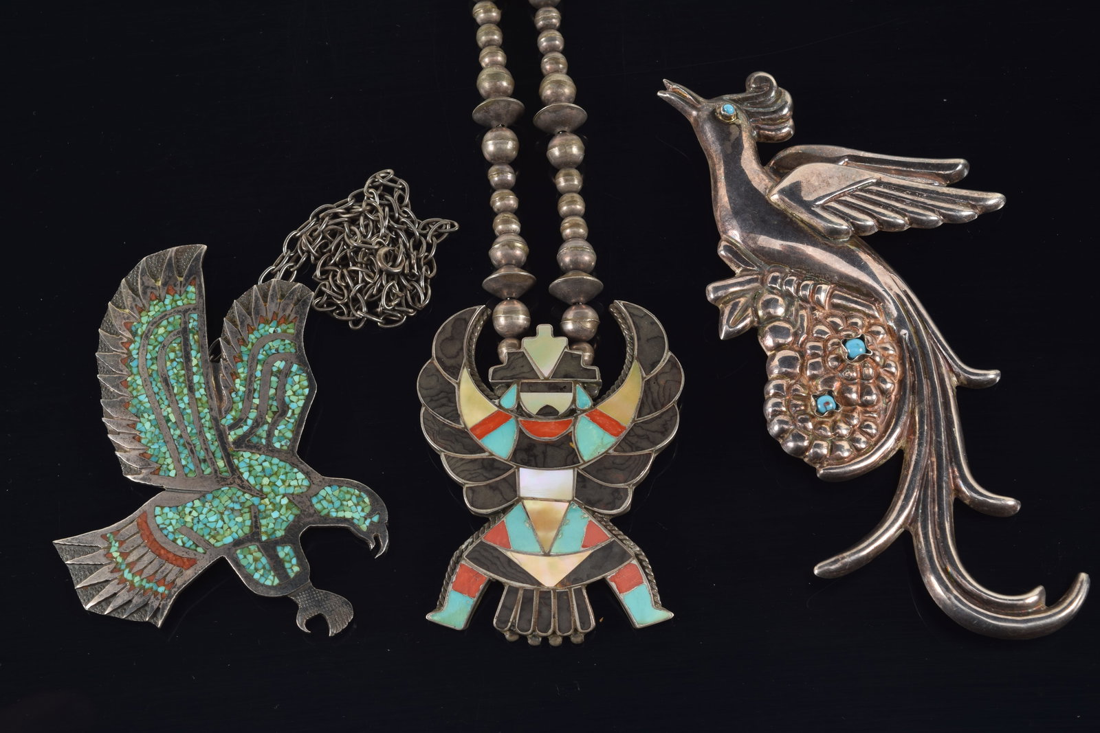 3 pieces of Mexican and Southwest silver jewelry. To include: 1) Large Mexican silver pin of a bird: 3 pieces of Mexican and Southwest silver jewelry. To include: 1) Large Mexican silver pin of a bird standing on floral branch and set with turquoise stones. 5.5in length. 2) Silver eagle pendant neckl