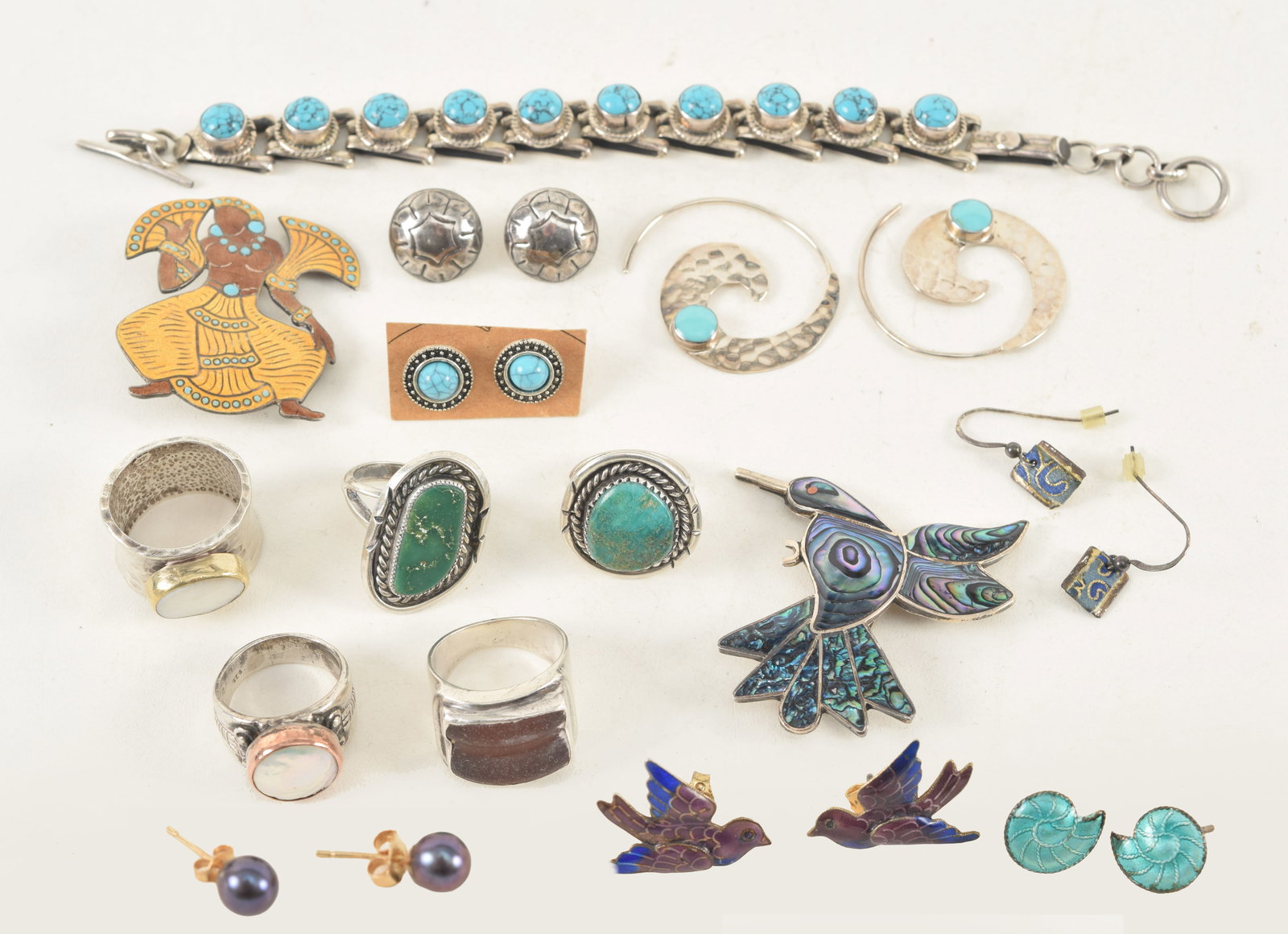 Lot of Mexican and Southwest silver jewelry. To include: 1) Margot de Taxco silver enamel Aztec: Lot of Mexican and Southwest silver jewelry. To include: 1) Margot de Taxco silver enamel Aztec dancer pin. 2) Turquoise mounted bracelet. 7.25in length. 3) Taxco abalone mounted hummingbird pin. 4) A
