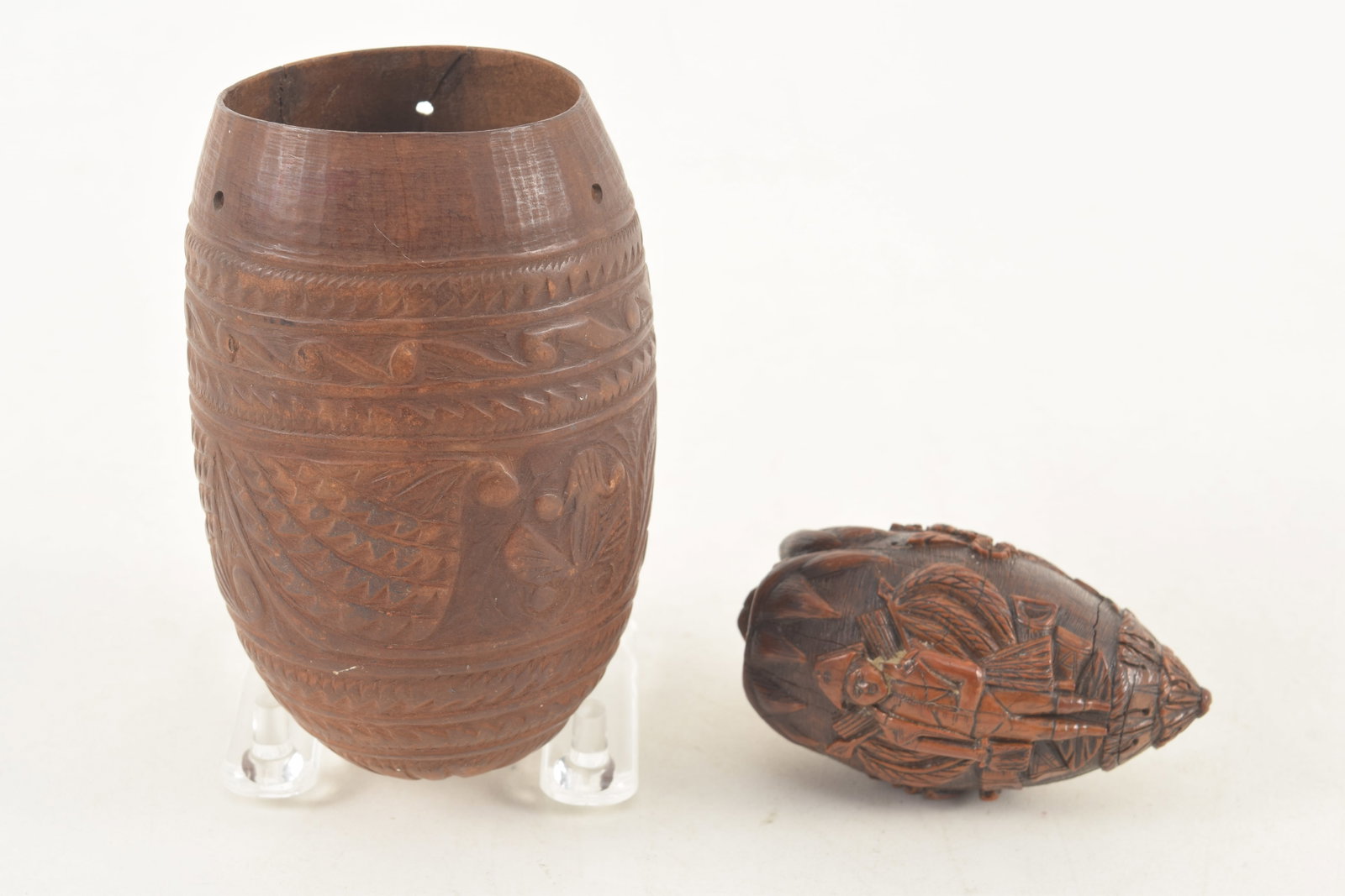 2 19th Century Sailor carved items, including a finely carved coquilla nut with sailor and basket of: 2 19th Century Sailor carved items, including a finely carved coquilla nut with sailor and basket of flowers and a carved gourd foliate scrollwork. Lengths 3 and 4 1/4 in.