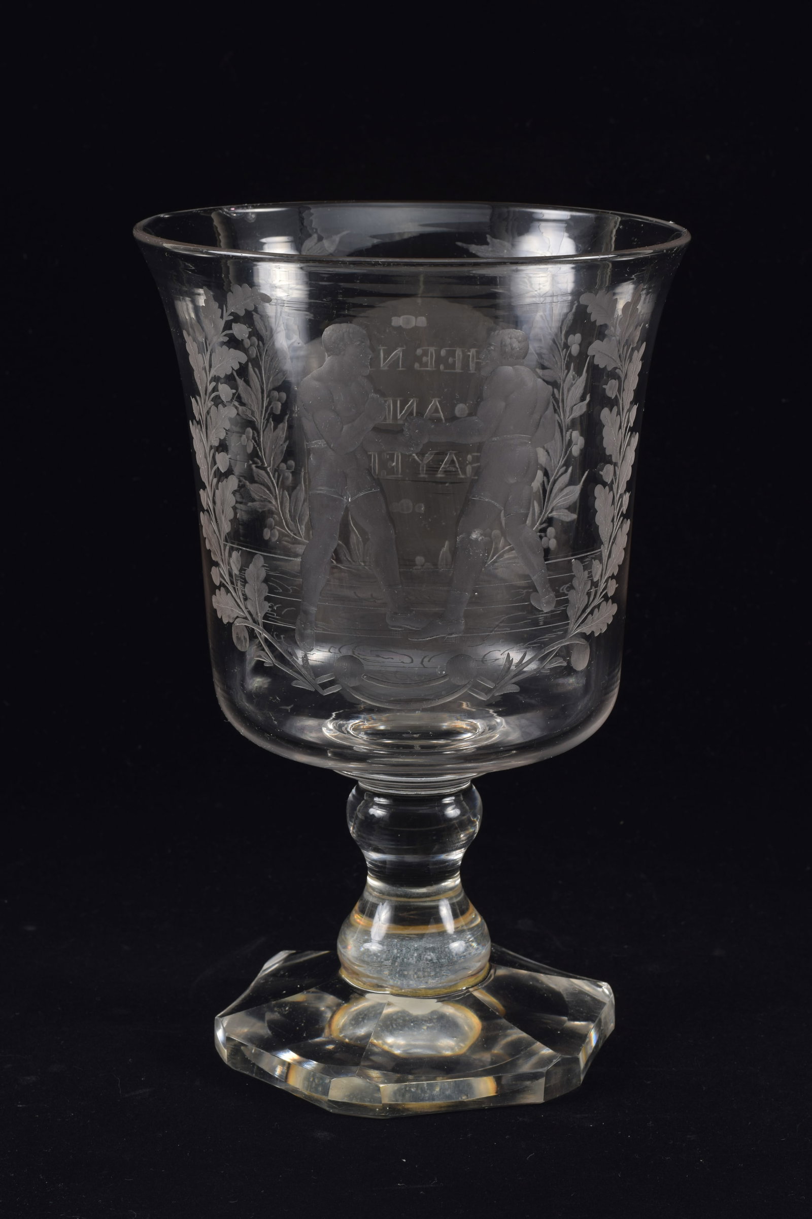 Rare John C. Heenan and Tom Sayers boxing match glass vase, mid 19th century. Trophy form etched: Rare John C. Heenan and Tom Sayers boxing match glass vase, mid 19th century. Trophy form etched glass vase with images of the American and English boxers commemorating their renowned championship fig