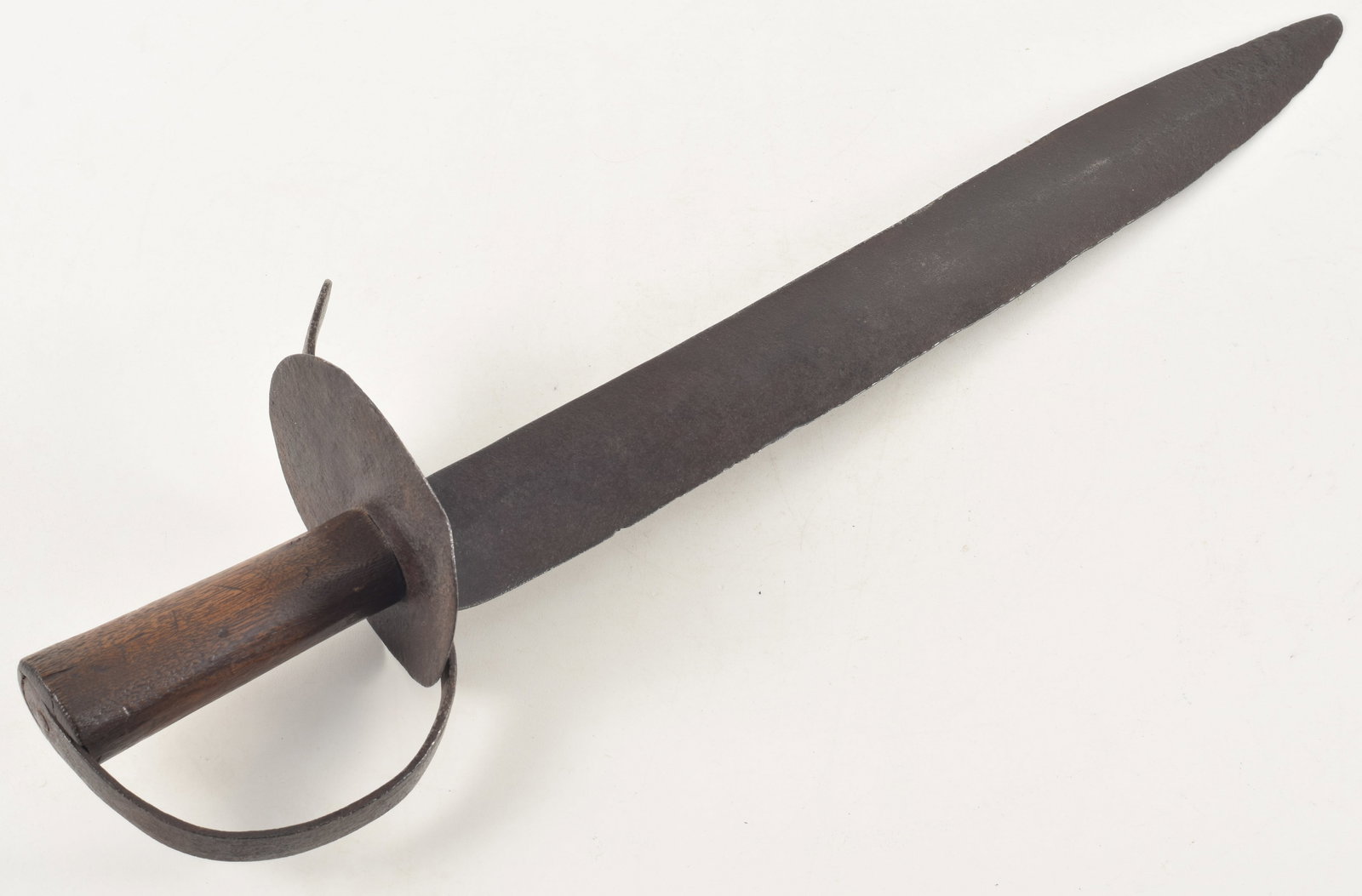 Civil War era short sword, possibly Confederate. Crude construction with wooden handle. Guard with: Civil War era short sword, possibly Confederate. Crude construction with wooden handle. Guard with dents. Blade with dents and chips. Pitting overall. One side of ricasso partially marked "Warranted C