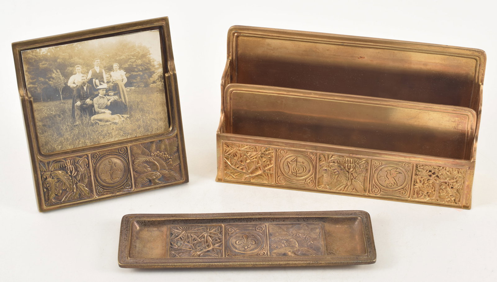 Tiffany Studios 3 piece Bookmark pattern desk set including a letter rack marked 1020, a pen tray: Tiffany Studios 3 piece Bookmark pattern desk set including a letter rack marked 1020, a pen tray marked 1055 and a picture frame marked 945.