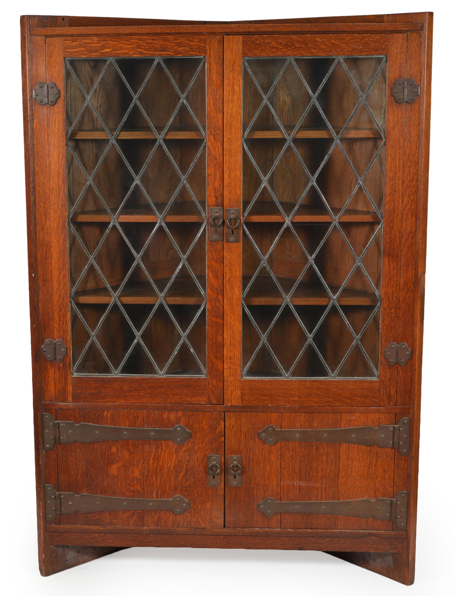 Gustav Stickley quarter sawn oak corner cabinet with patinated hardware and leaded glass windows,: Gustav Stickley quarter sawn oak corner cabinet with patinated hardware and leaded glass windows, model 964, circa 1902. Upper glazed cabinet with three shelves above cabinet doors with long strap hin