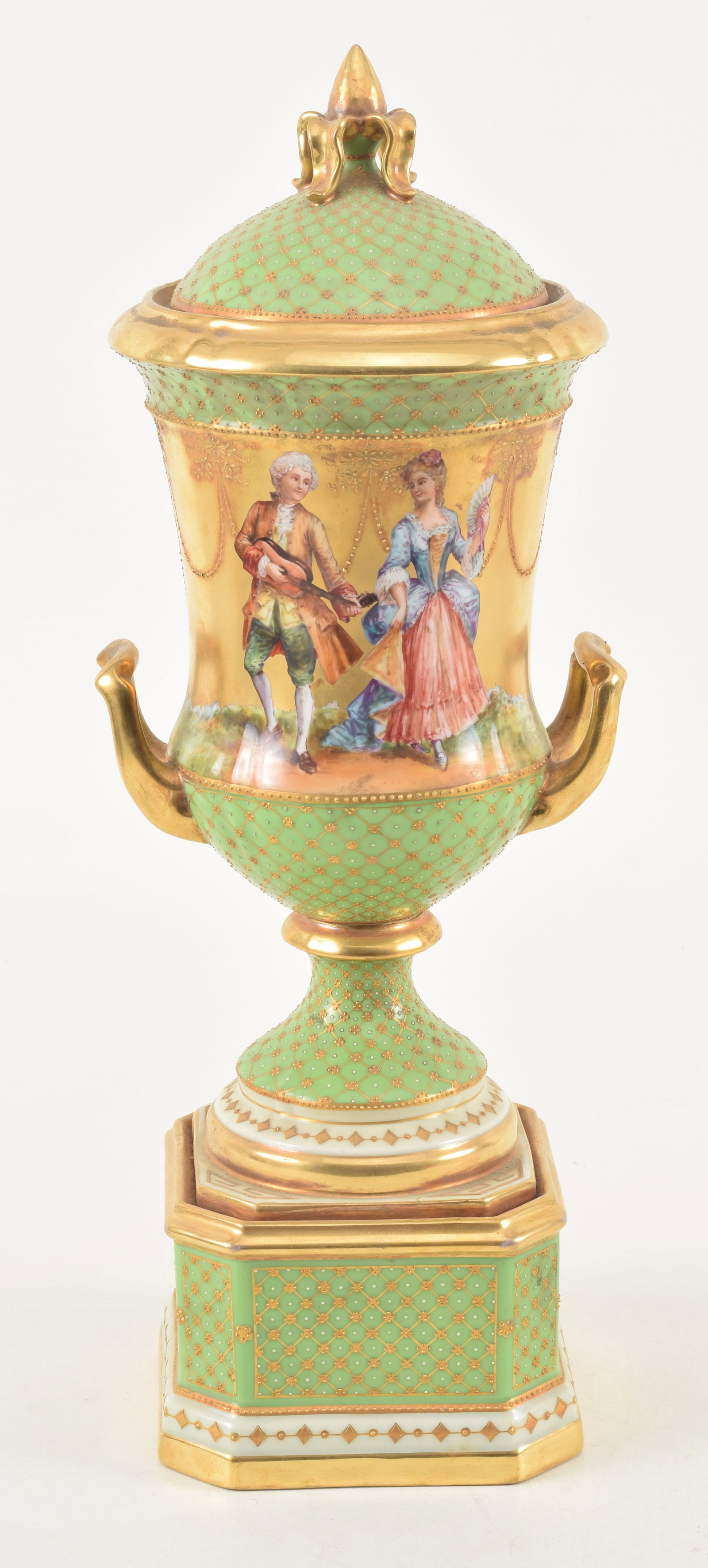 Dresden porcelain covered urn on plinth, 19th century. Hand painted motifs of figures playing music: Dresden porcelain covered urn on plinth, 19th century. Hand painted motifs of figures playing music and dancing on gilt ground. Applied gilt and white enamel dot crosshatch pattern on bright green gro