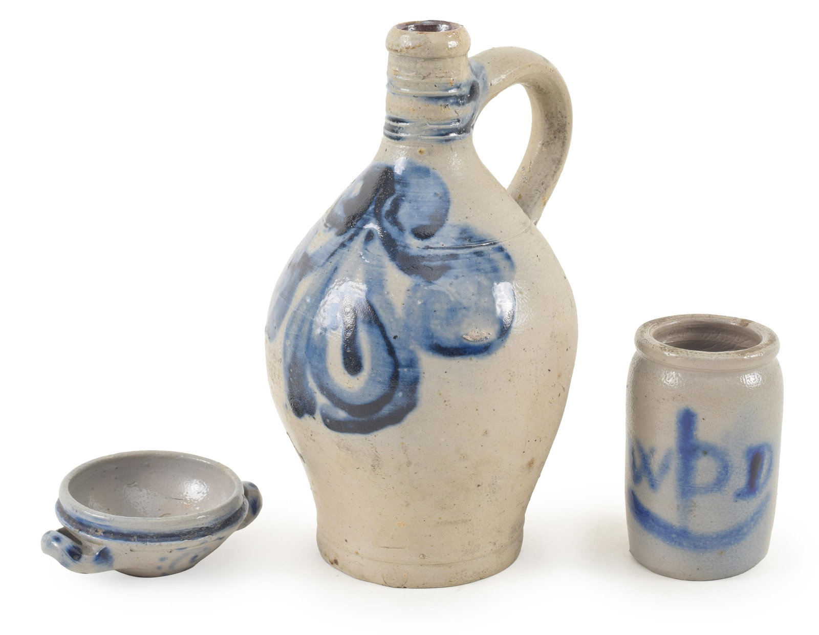 3 pieces of blue decorated stoneware, including: 1) Decorated blue ovoid handled jug, 18th century.: 3 pieces of blue decorated stoneware, including: 1) Decorated blue ovoid handled jug, 18th century. 7.5in high. 2) Small crock with blue decorated initials, 19th century. 3.25in high. 3) 19th century 