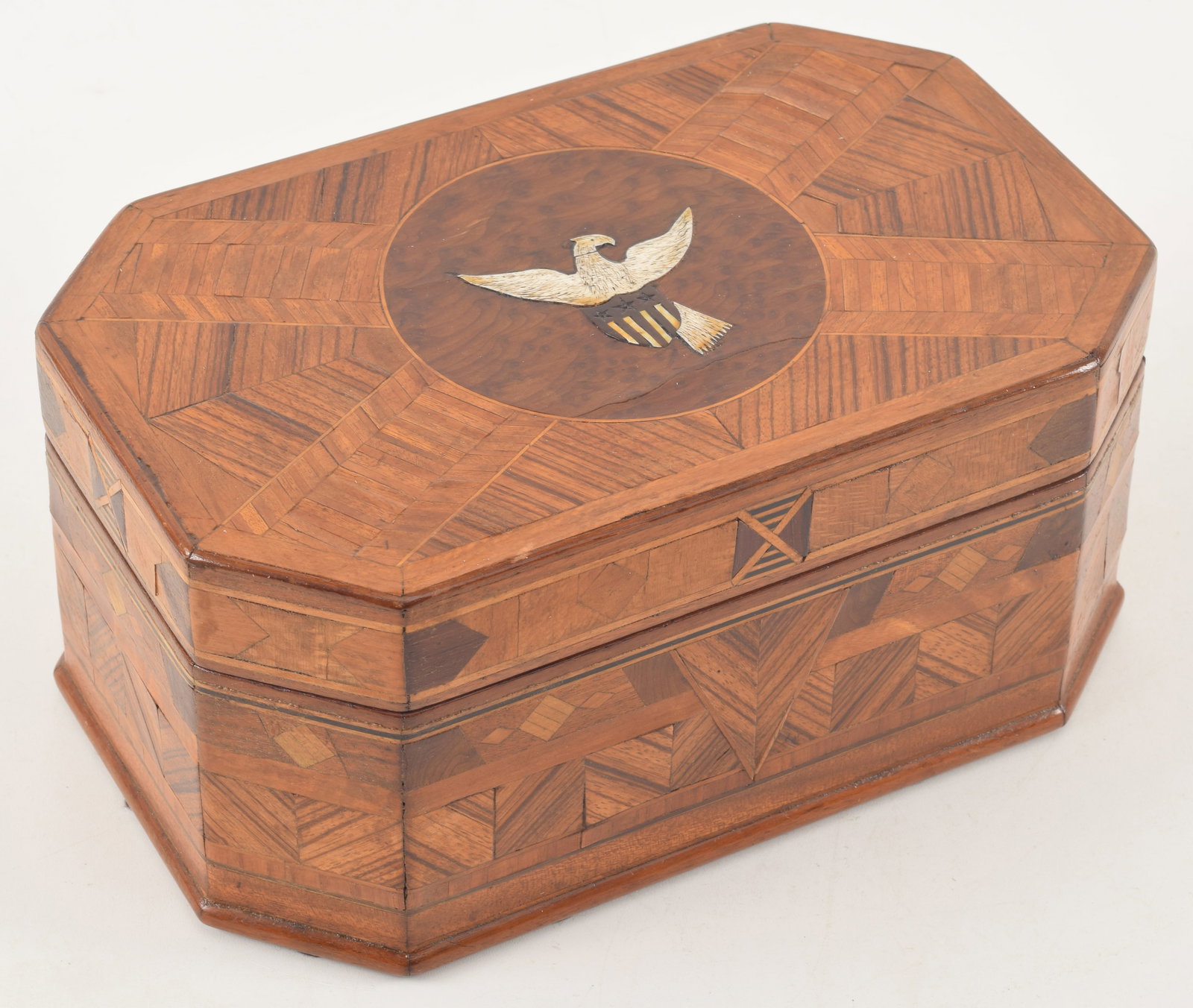 19th century American inlaid parquetry box. Octagonal form. Lid with inlaid American Eagle in round: 19th century American inlaid parquetry box. Octagonal form. Lid with inlaid American Eagle in round field. Top and sides with geometric patterns and designs in various woods. Interior lined with suede