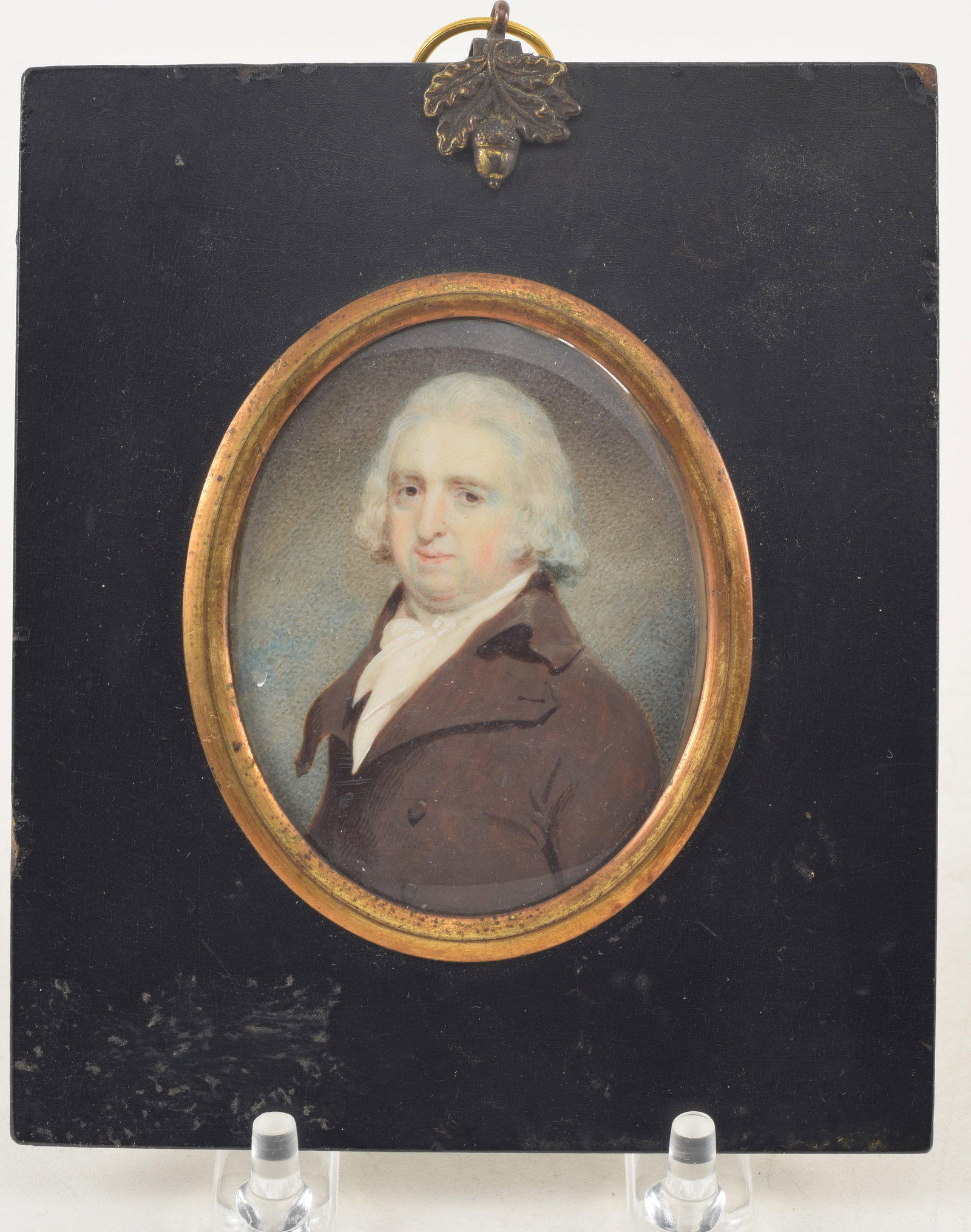 Early 19th Century portrait miniature of a gentleman in a brown coat. Framed with gilded bezel.: Early 19th Century portrait miniature of a gentleman in a brown coat. Framed with gilded bezel. Image 2 7/8 x 2 3/8 in, overall size 5 1/4 x 4 1/2 in.