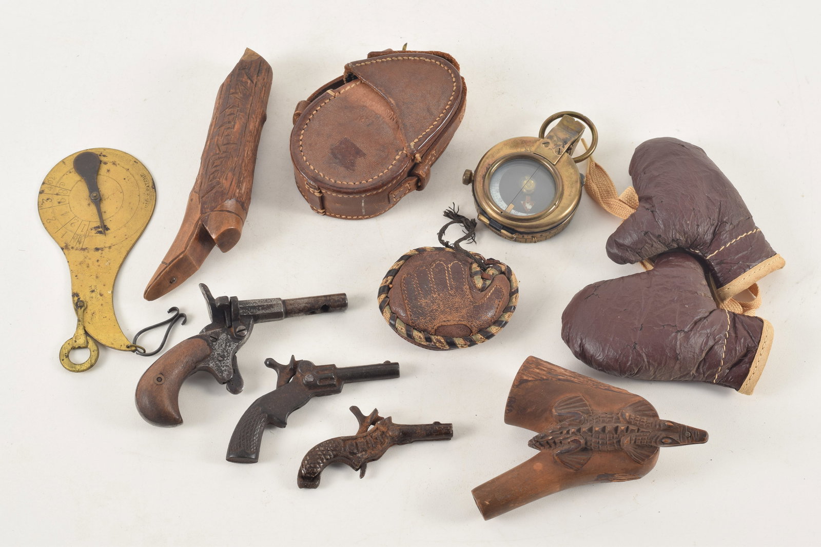Lot of antique curiosities including a cased compass, boot form peeper, miniature cap pistols, (1 of 12)