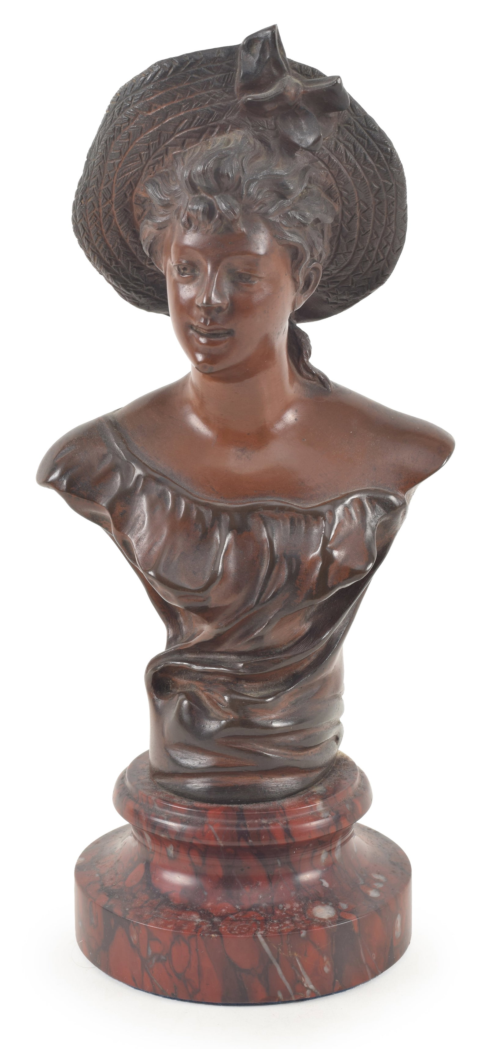 Jean Garnier bronze bust of a young woman wearing a straw hat. Signed on reverse. Mounted to a red: Jean Garnier bronze bust of a young woman wearing a straw hat. Signed on reverse. Mounted to a red marble base. Bronze: 7.5in high. Overall: 9.5in high.