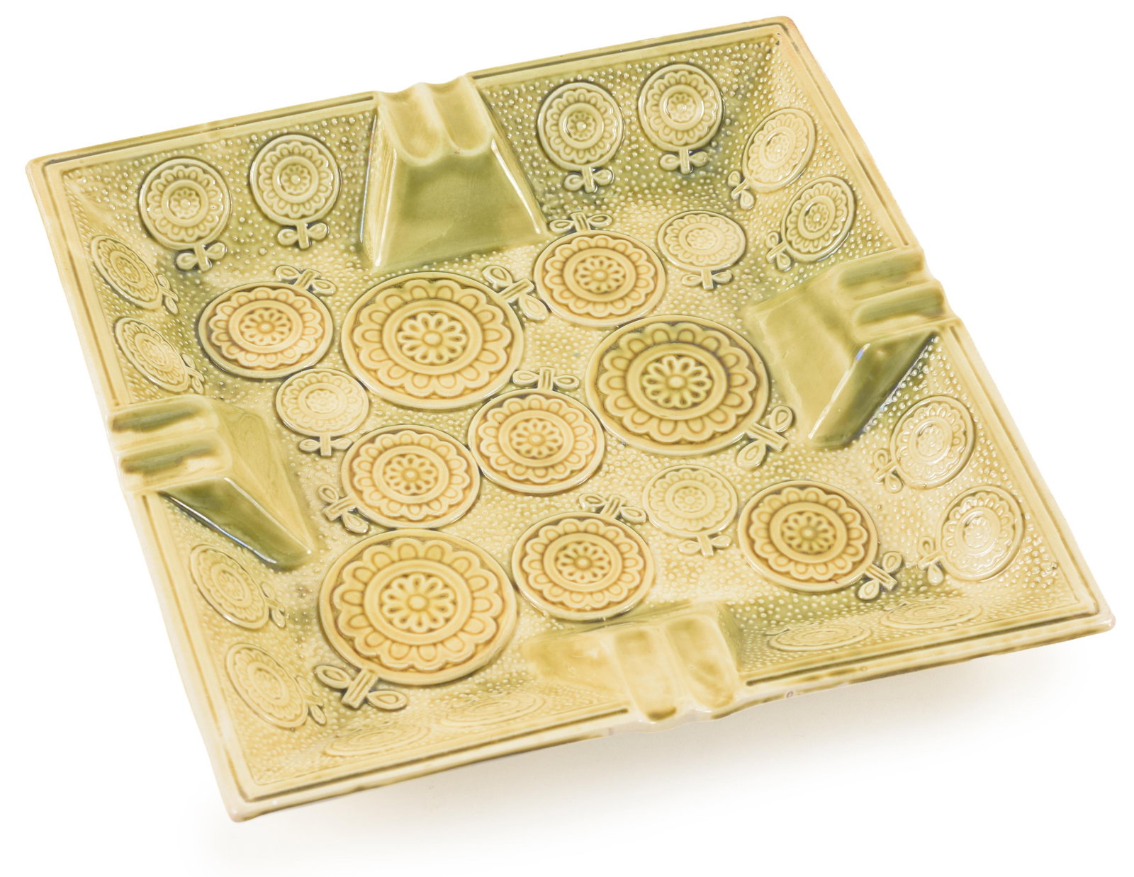 Unusual vintage glazed ceramic ashtray with relief decoration of various-sized roundels on a dimpled: Unusual vintage glazed ceramic ashtray with relief decoration of various-sized roundels on a dimpled ground. Pale green glaze. Unmarked. 9.5in square.