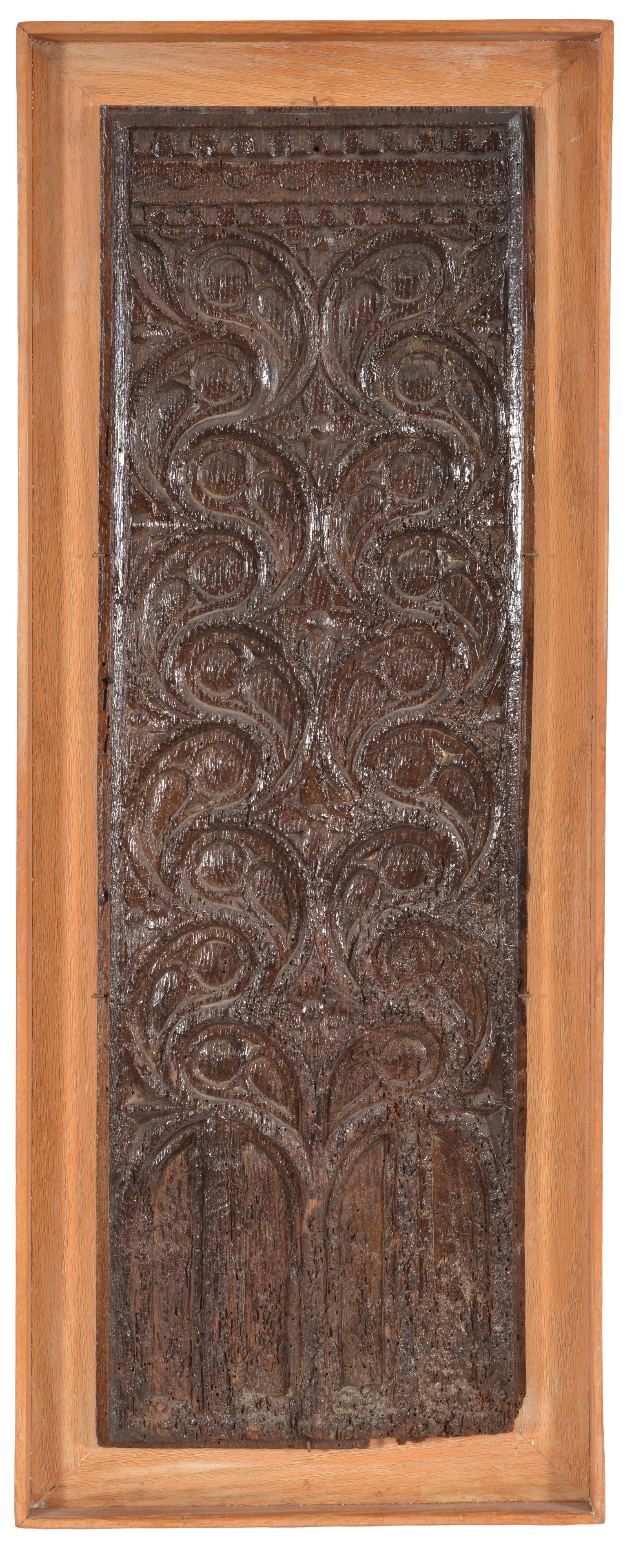 Early architectural carved oak panel, 16th/17th century. Repeating scrolling pattern above paneled: Early architectural carved oak panel, 16th/17th century. Repeating scrolling pattern above paneled archways. Contemporary frame. Overall: 34.5 x 13.5in.
