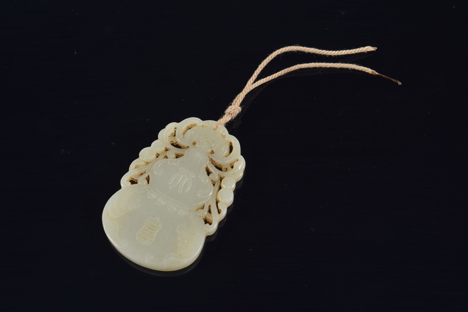 Jade pendant. China. 19th century. Double gourd form. 2.25in. - 2
