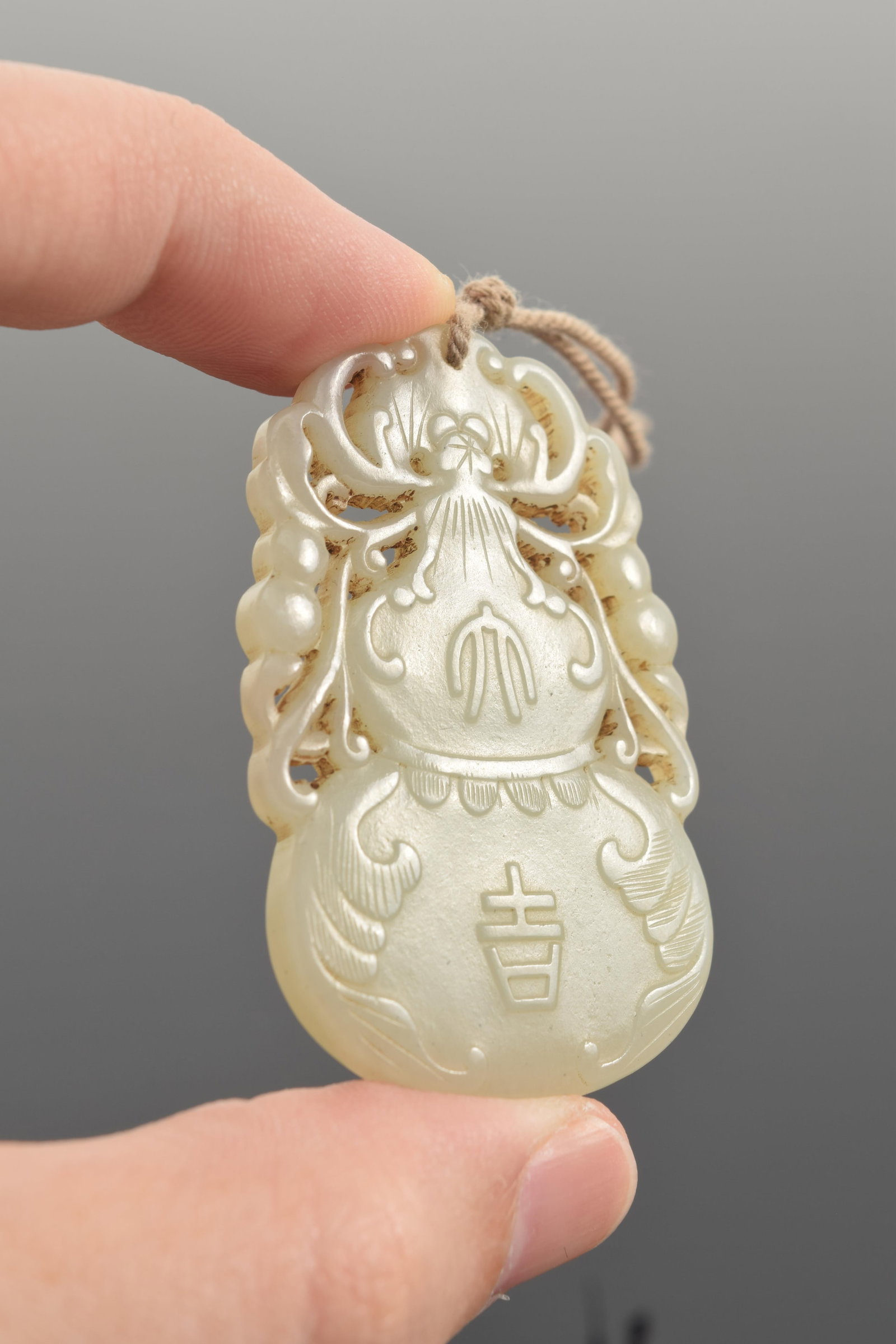 Jade pendant. China. 19th century. Double gourd form. 2.25in. - 5