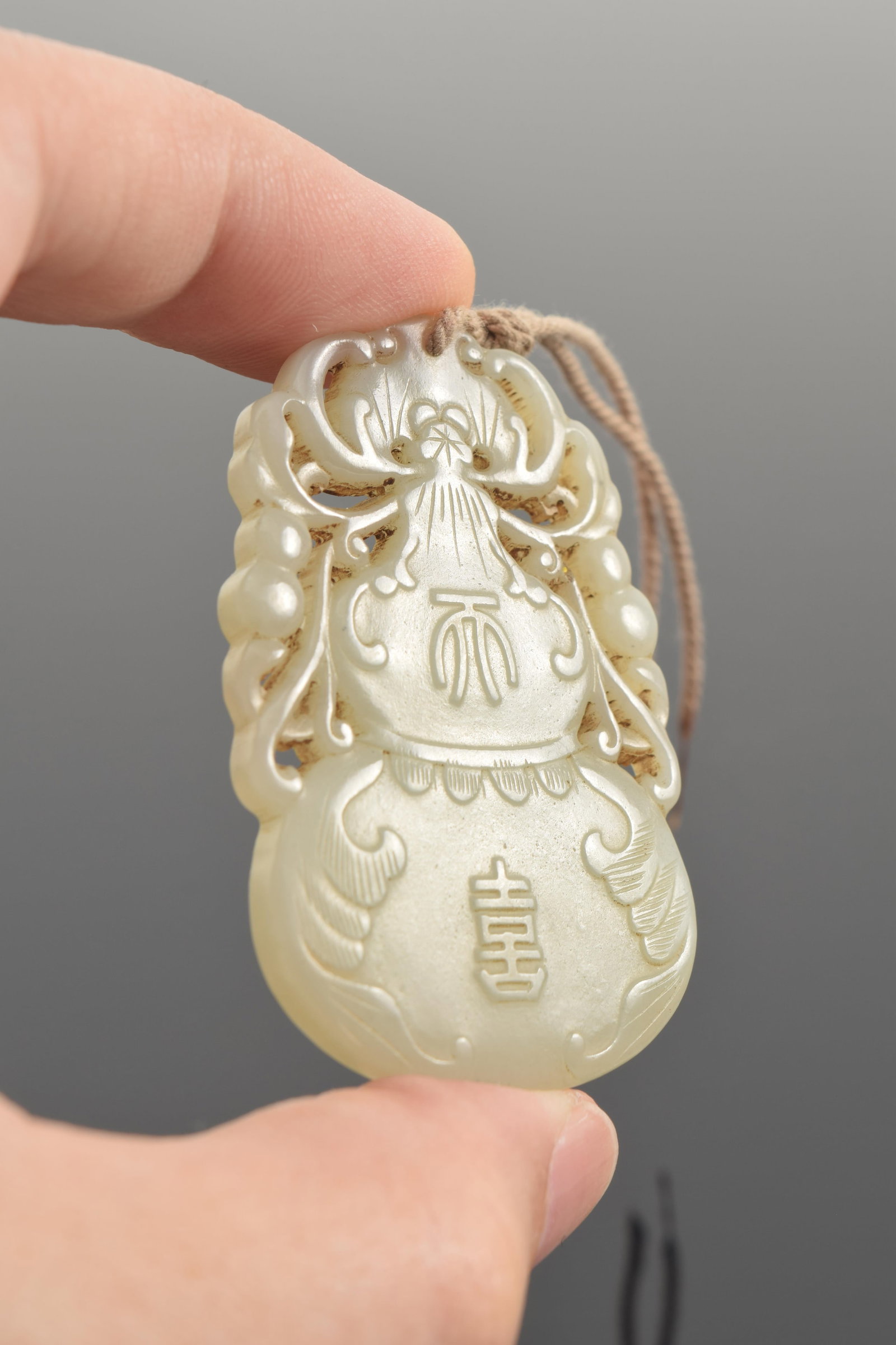 Jade pendant. China. 19th century. Double gourd form. 2.25in. - 6