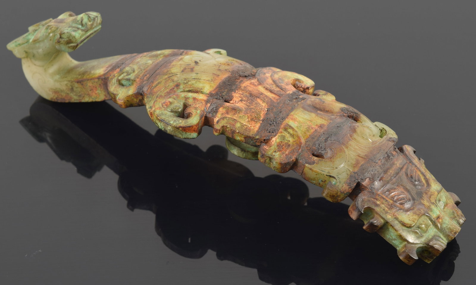 Garment hook. China. Waring states period. Burial patina with areas of bronze coloring the jade. (1 of 7)