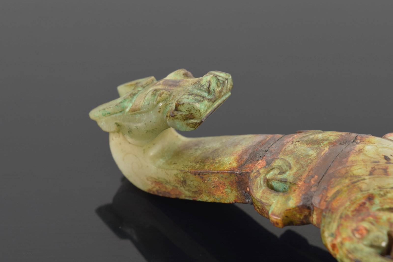 Garment hook. China. Waring states period. Burial patina with areas of bronze coloring the jade. - 2