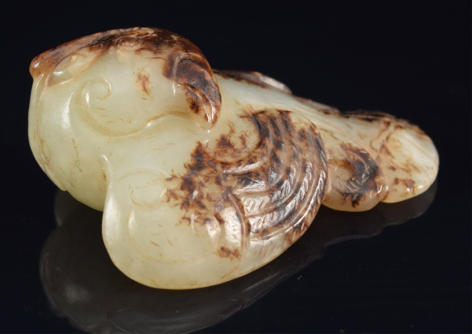 Jade pendant. China. 18th century or earlier. Carved as a dove. Celadon stone with black skin. (1 of 6)